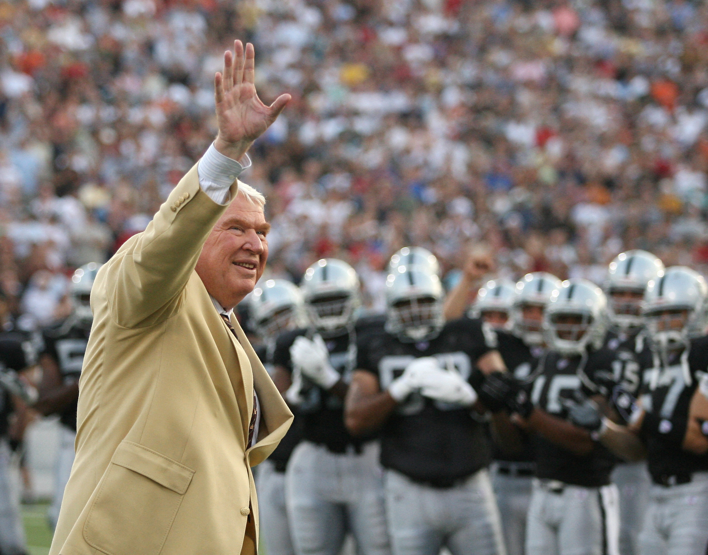 Former Oakland Raiders' coach John Madden waves to the crowd before the Hall of Fame game in Canton, Ohio