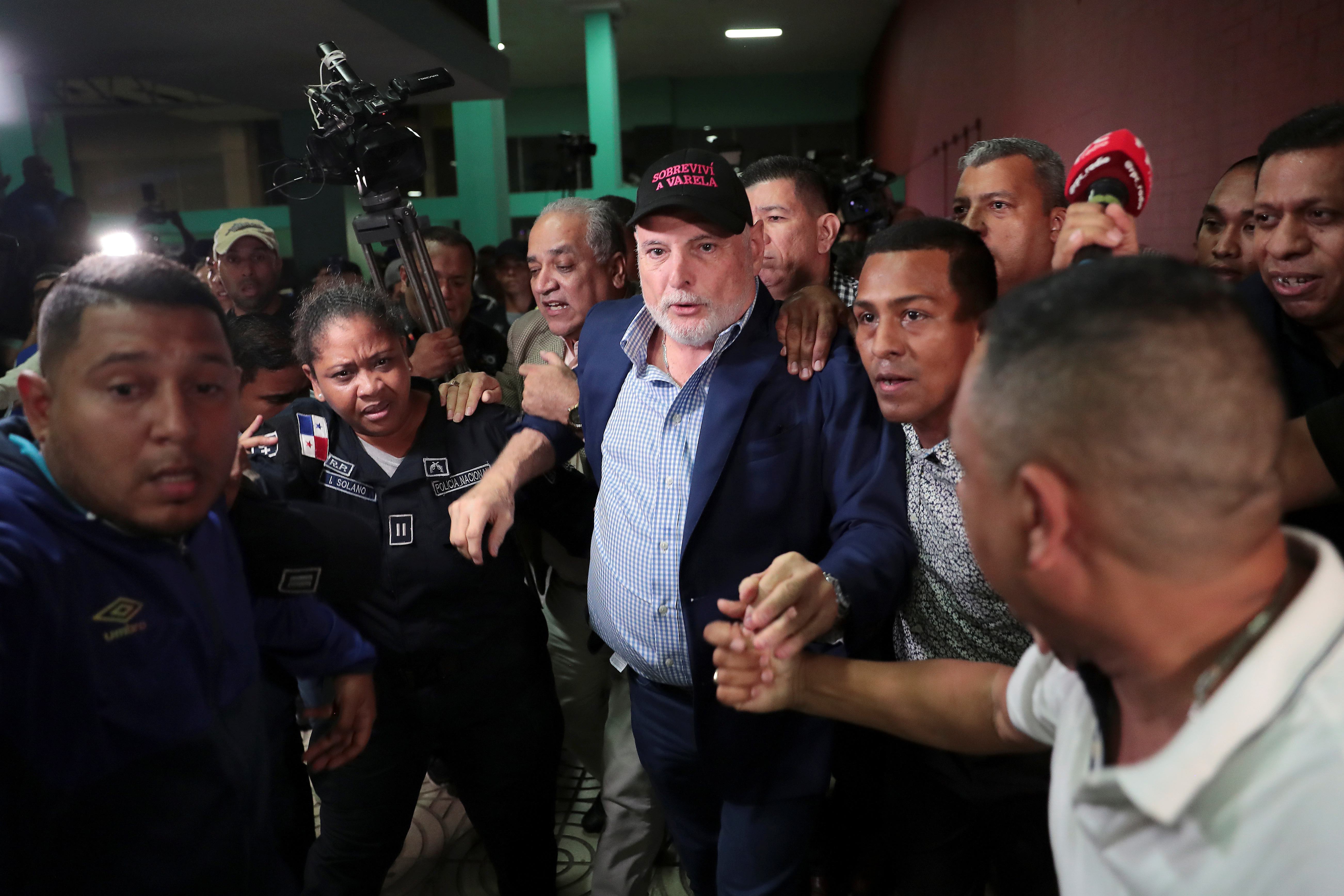 Panama's former president Ricardo Martinelli is escorted by police officers and supporters while leaving a courthouse after being declared not guilty of spying charges in Panama City