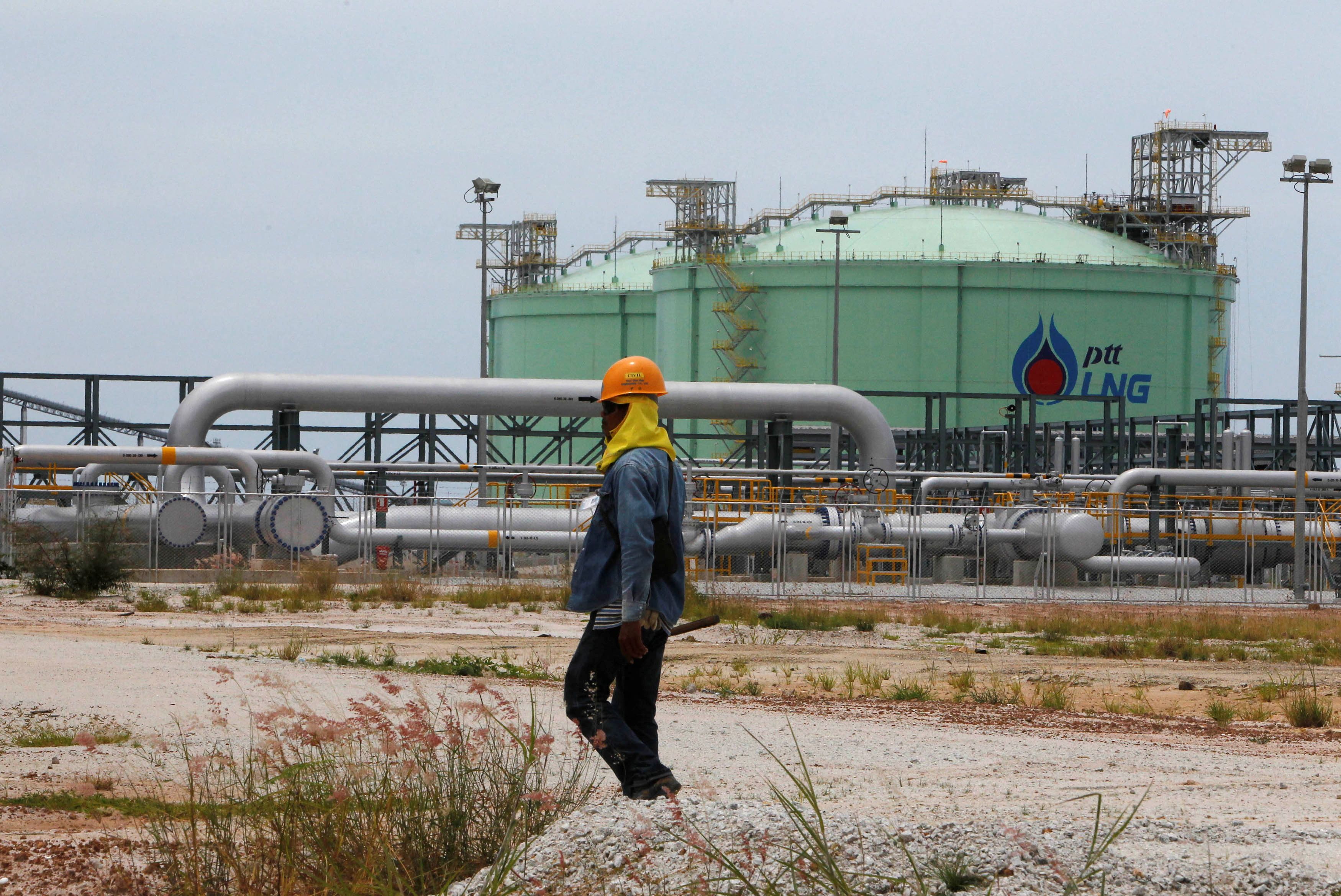 A PTT employee walks outside the firm's new $880 million Liquefied Natural Gas terminal at the Map Ta Phut industrial estate
