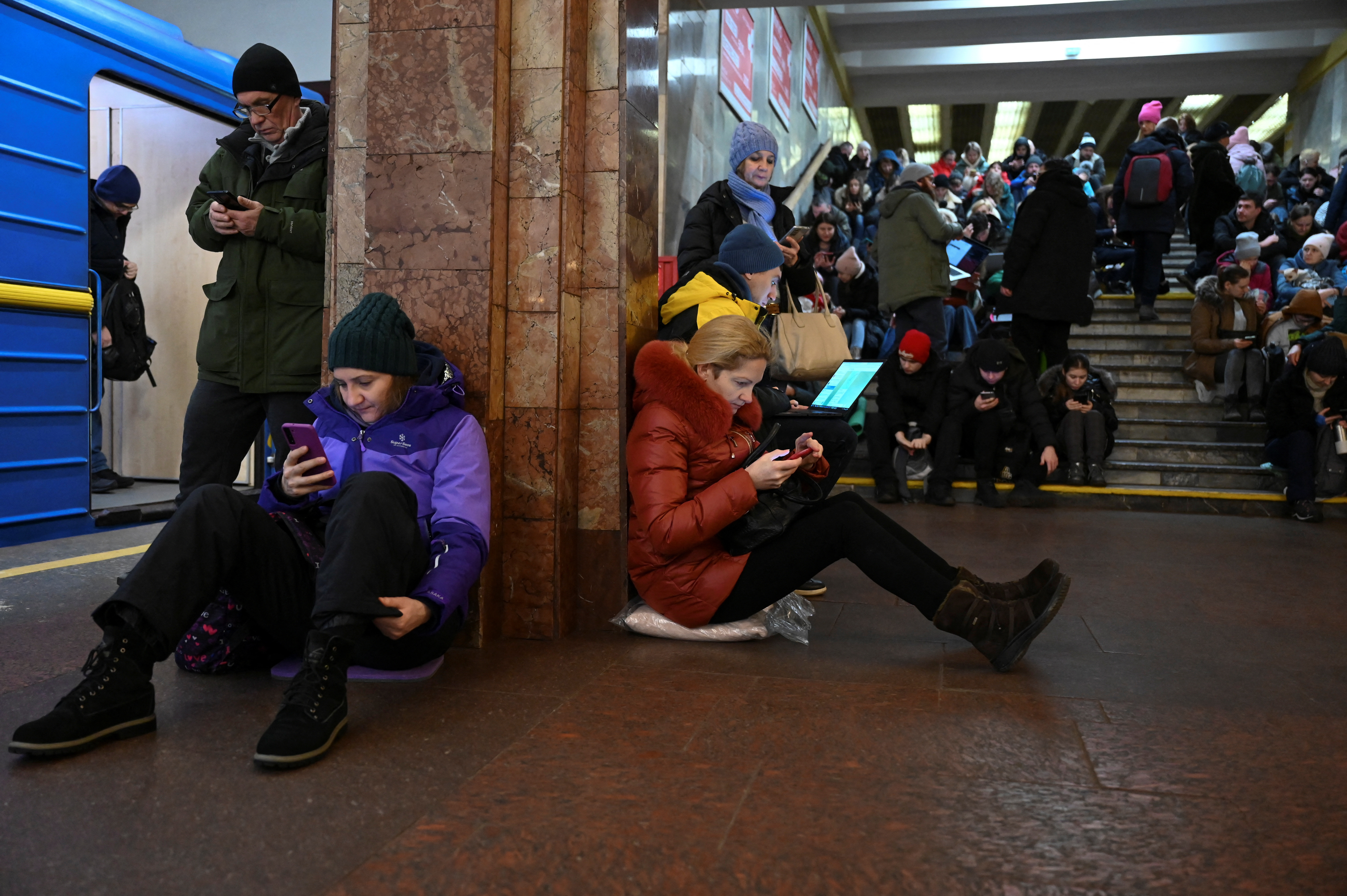 People take shelter inside a metro station during massive Russian missile attacks in Kyiv