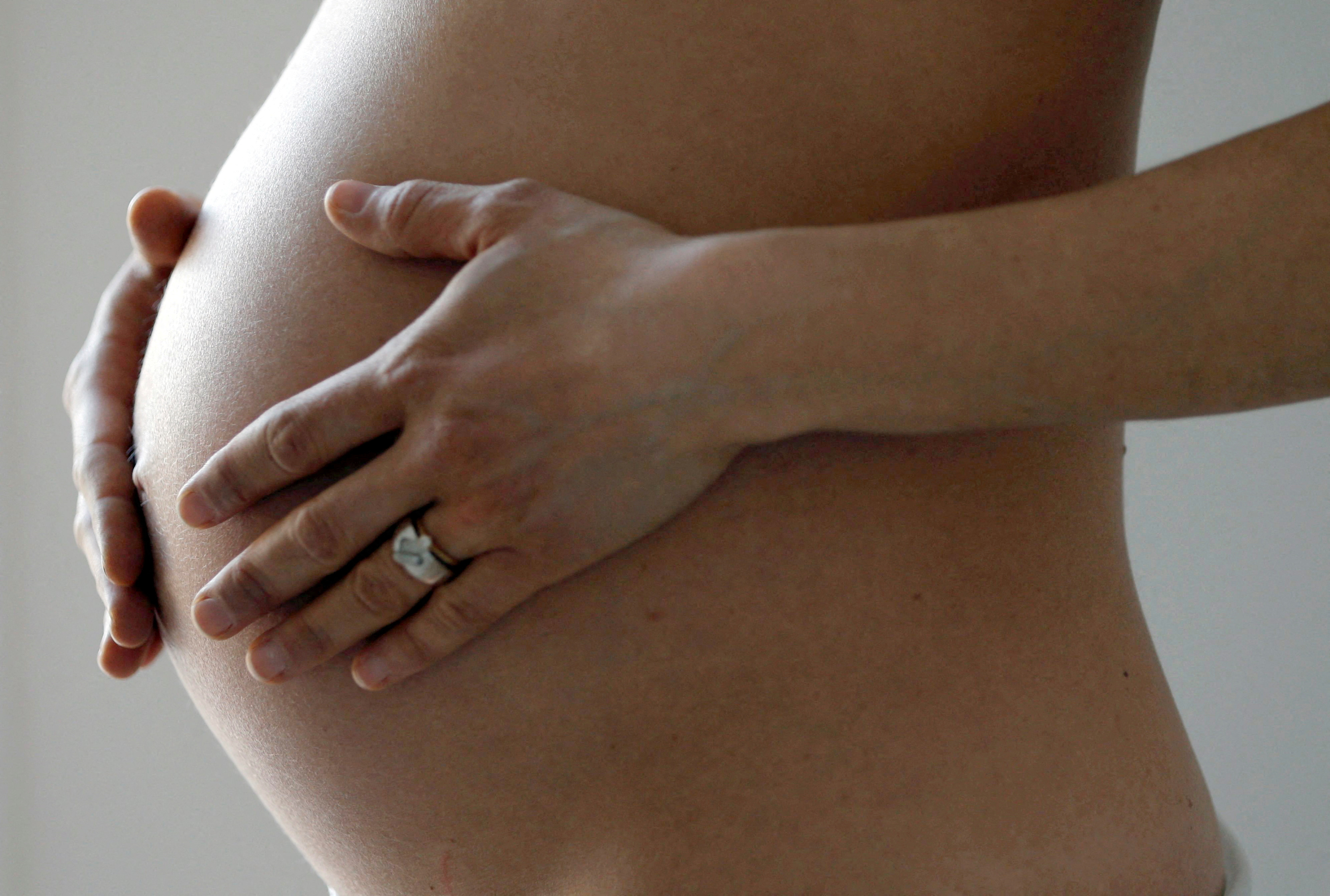 A pregnant woman, in the last trimester of her pregnancy, poses in this illustration photo in Sete