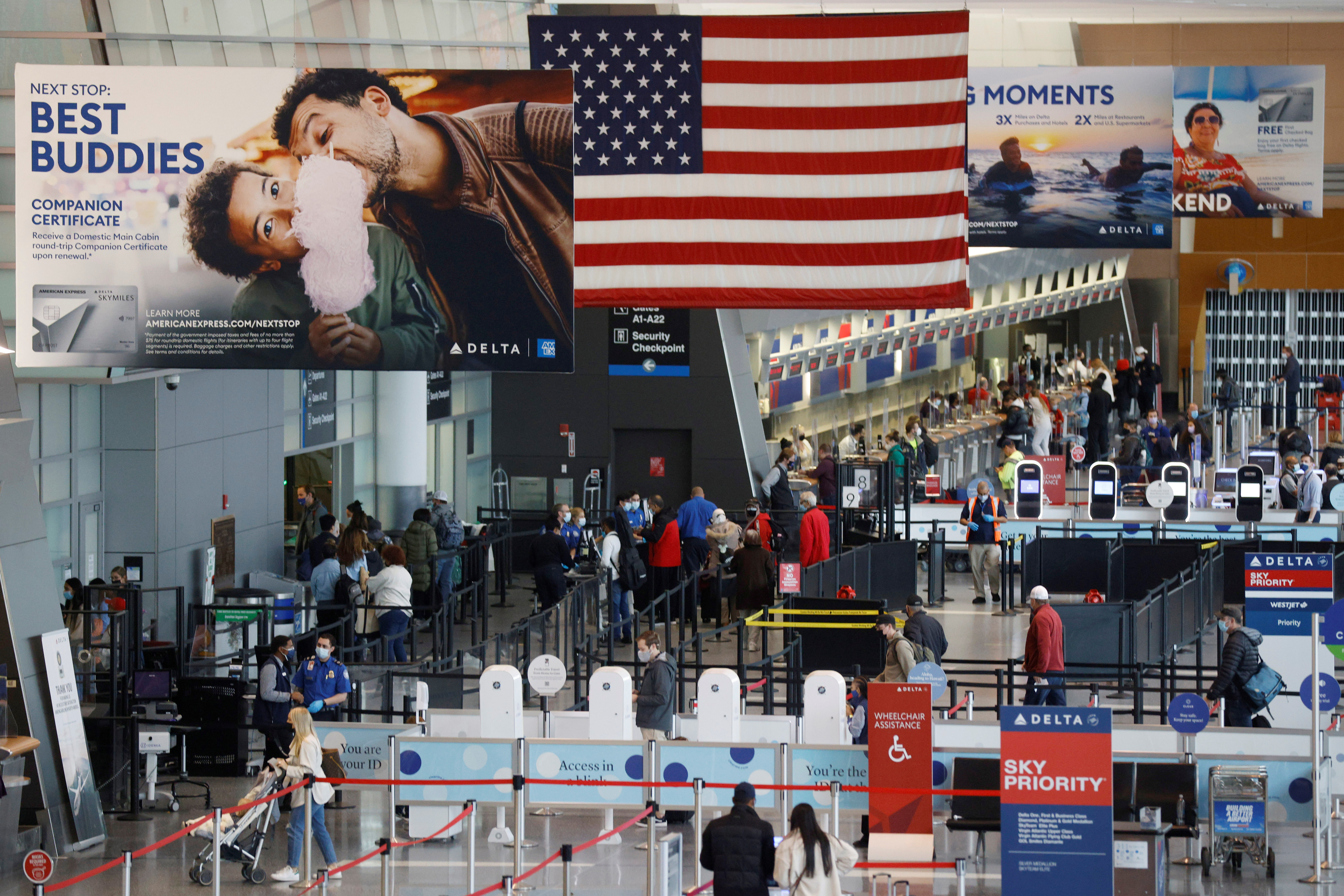 Passengers travel through Logan Airport in Boston