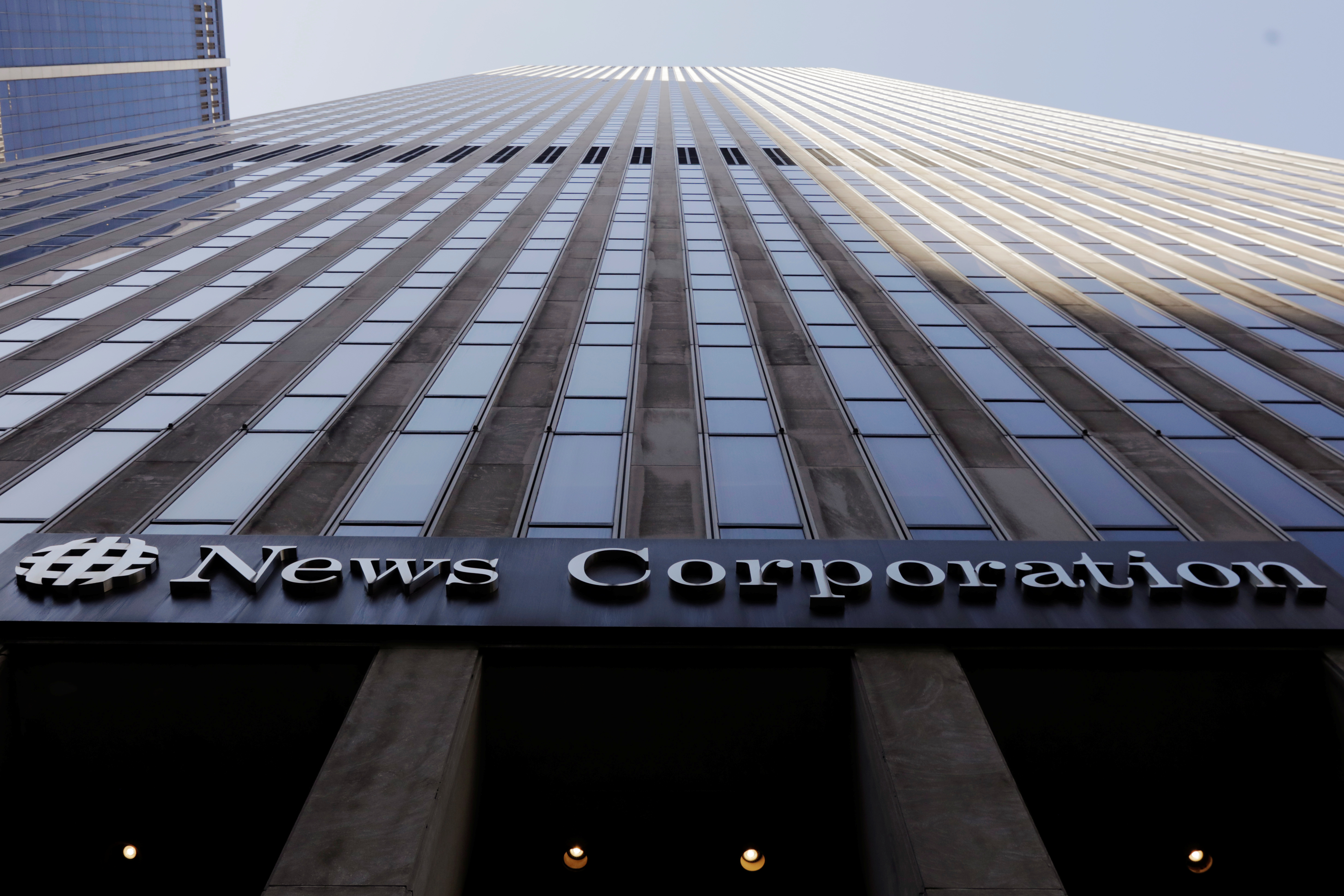The News Corporation logo is displayed on the side of a building in midtown Manhattan in New York
