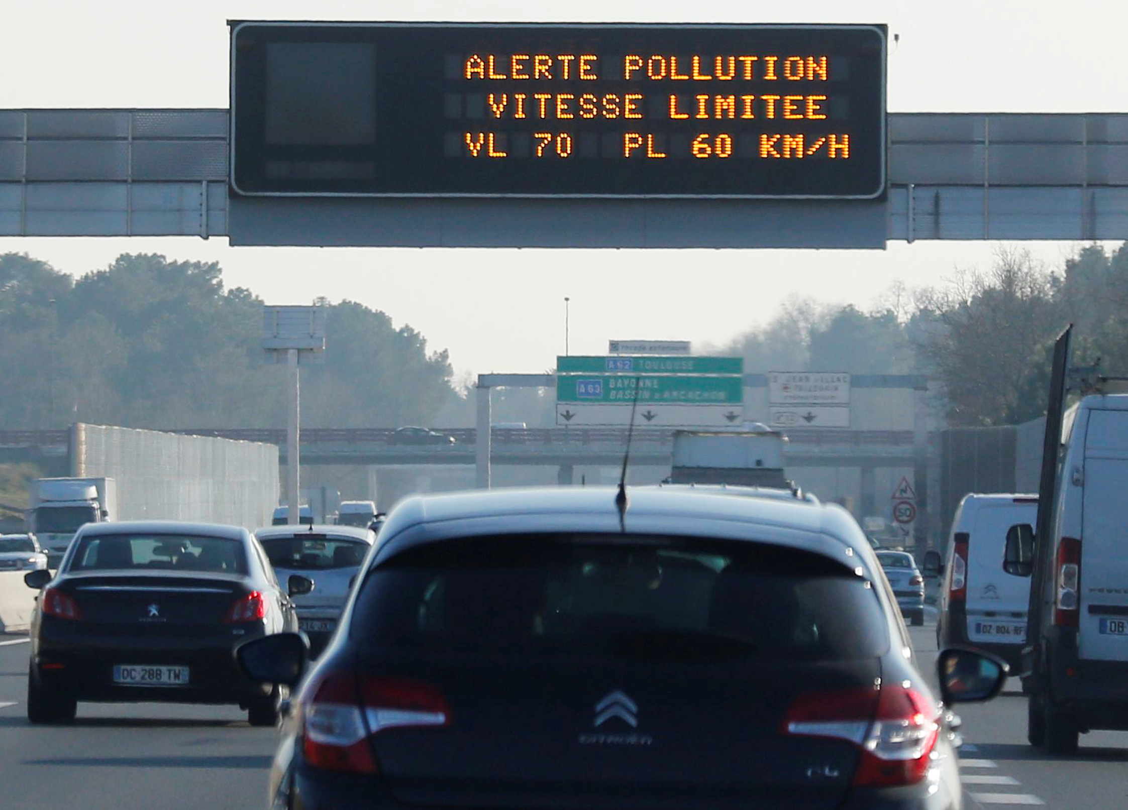 An electronic road sign reads "Pollution, speed limit 70km/h for passenger cars" on the Bordeaux ring road
