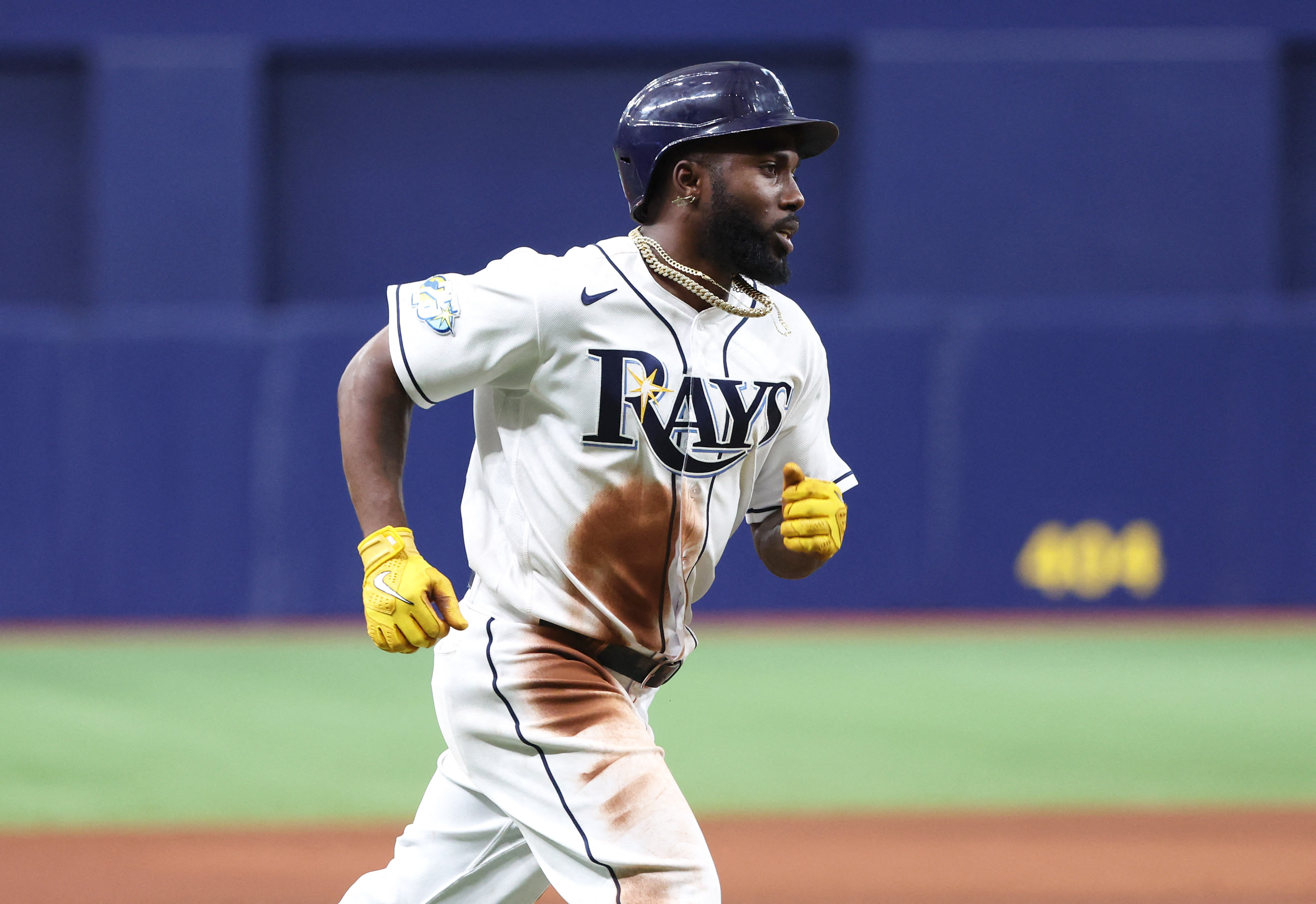 Tampa Bay Rays' Randy Arozarena is congratulated by teammates after scoring  the in the ninth inning of a baseball game against the Cleveland Indians,  Friday, July 23, 2021, in Cleveland. (AP Photo/Tony