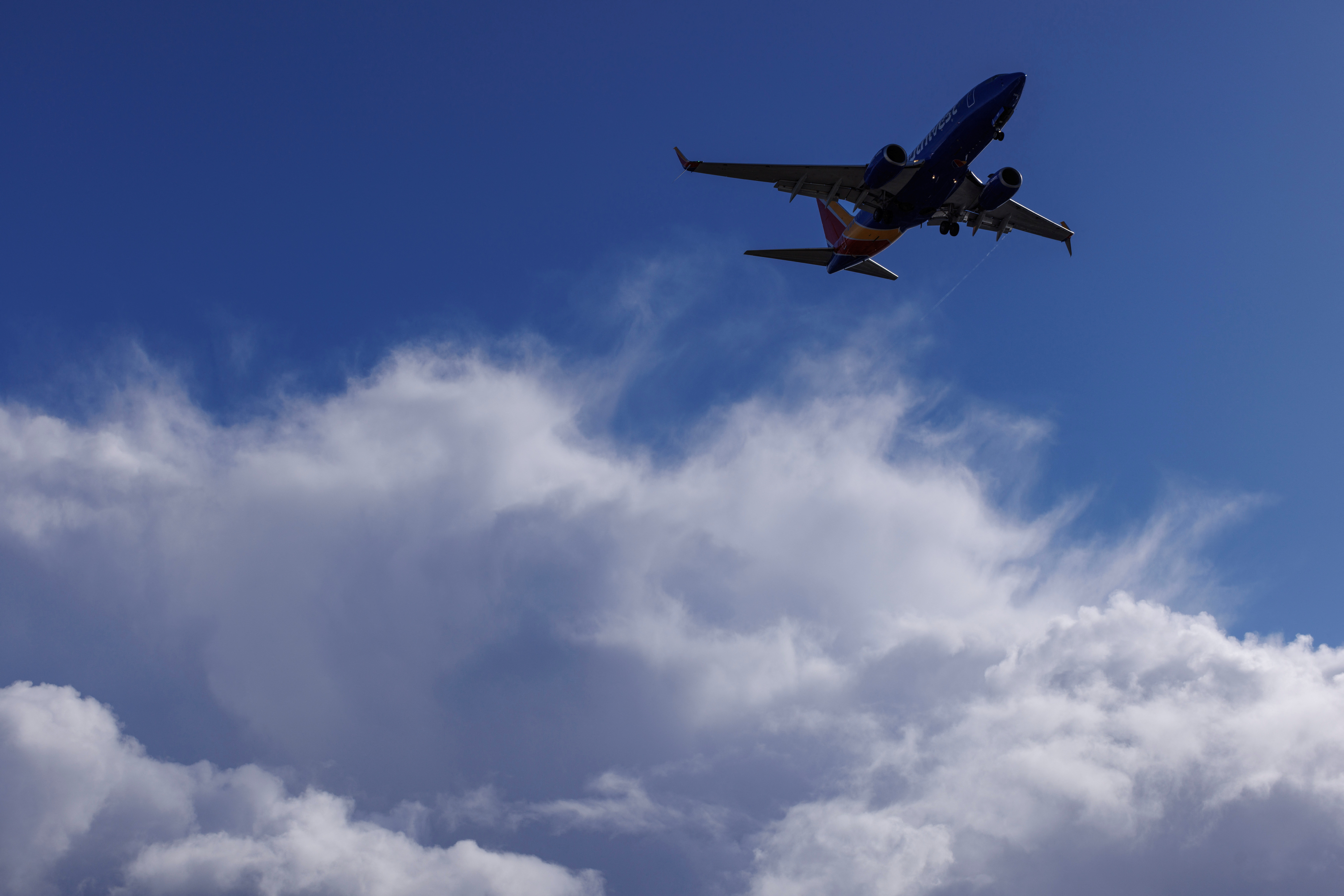 A Southwest Airlines flight descends past stpmy sky in California