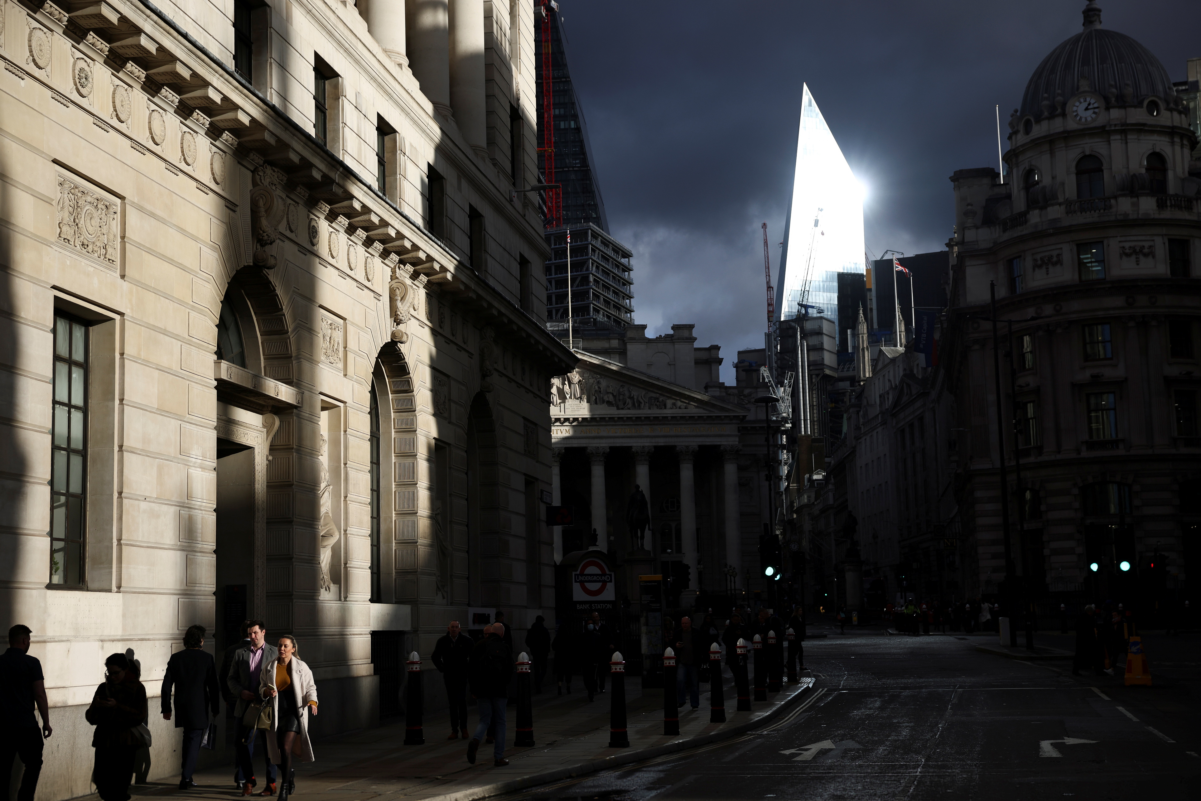People walk through the City of London financial district, amid the coronavirus disease (COVID-19) outbreak in London