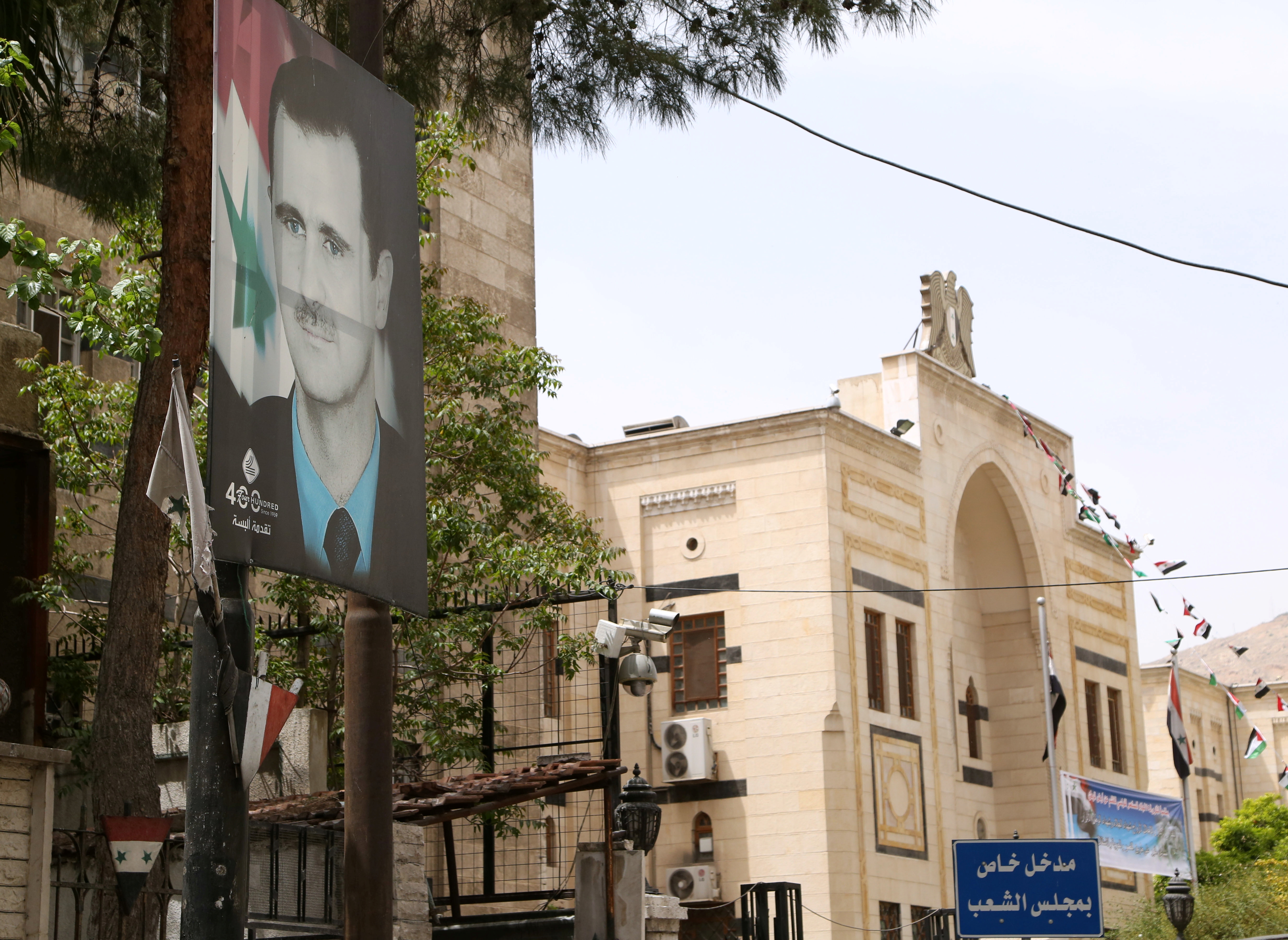 A picture of Syria's President Bashar al-Assad is pictured outside the parliament building in Damascus