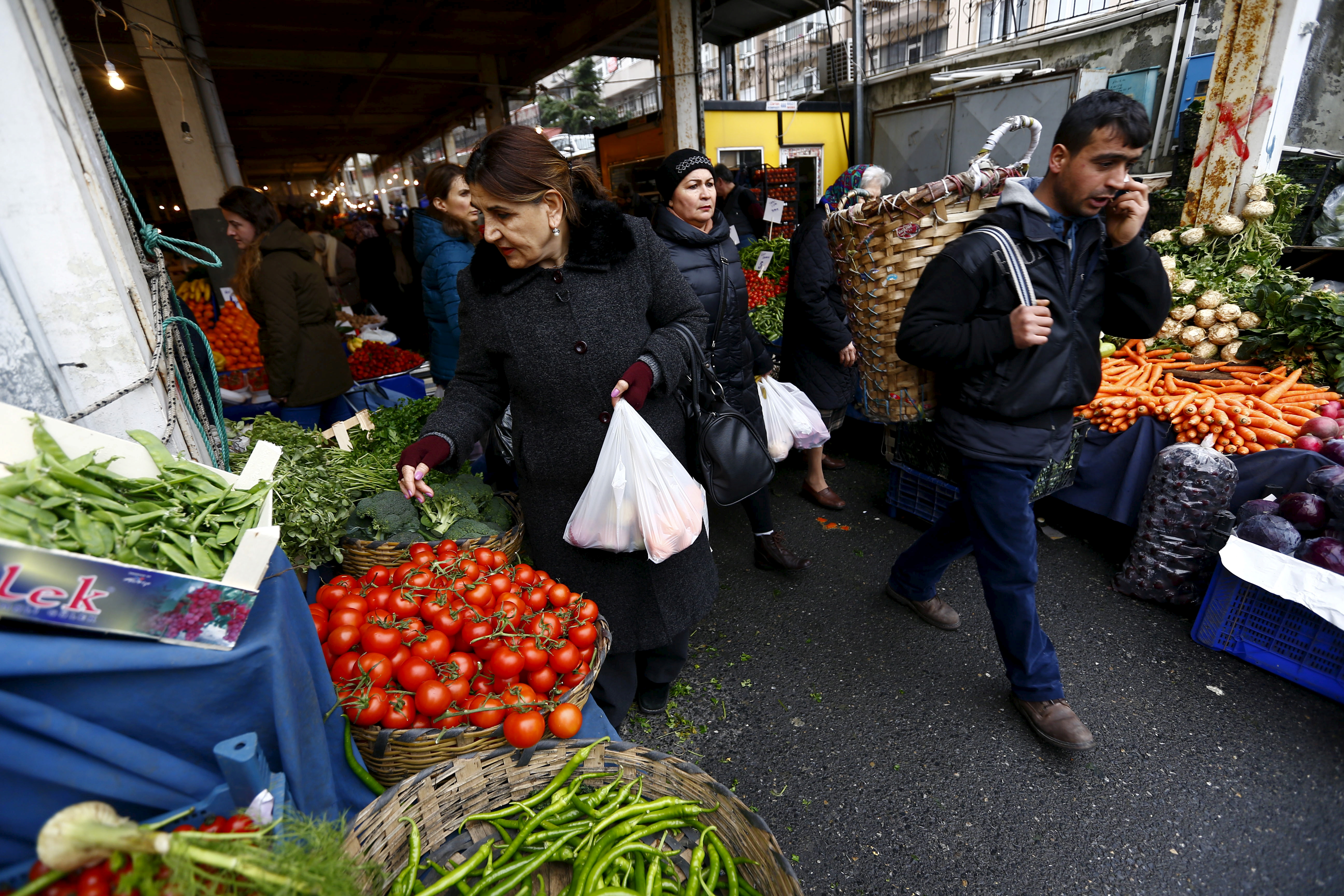 Gulsen Yuce shops at a bazaar in Istanbul Turkey January 30, 2016. Standing amid a jumble of food stalls in an Istanbul market, 61-year-old Yuce wonders how she can stretch an already tight budget to make ends meet as food prices rise