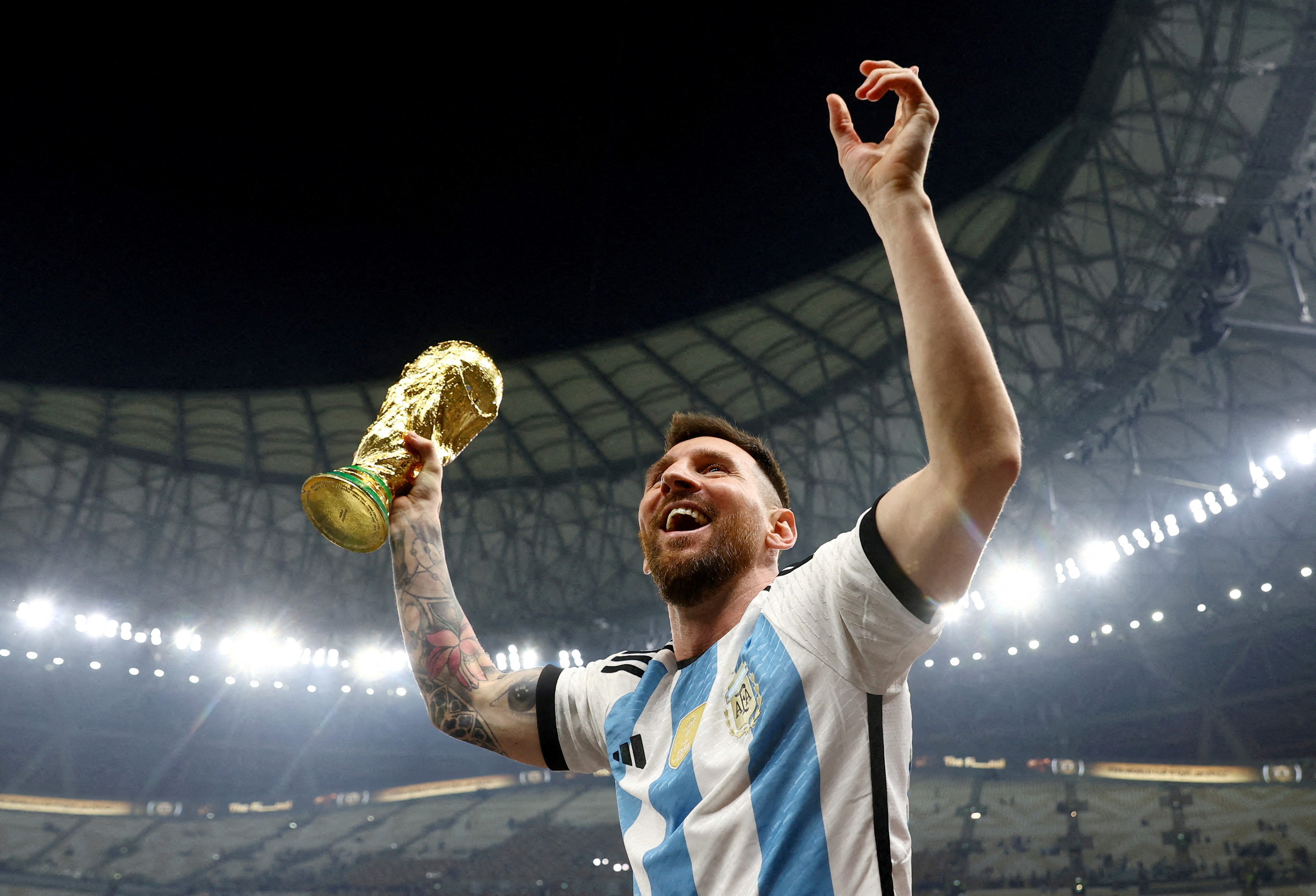 Argentina's Lionel Messi celebrates winning the World Cup with the trophy, Lusail, Qatar - December 18, 2022