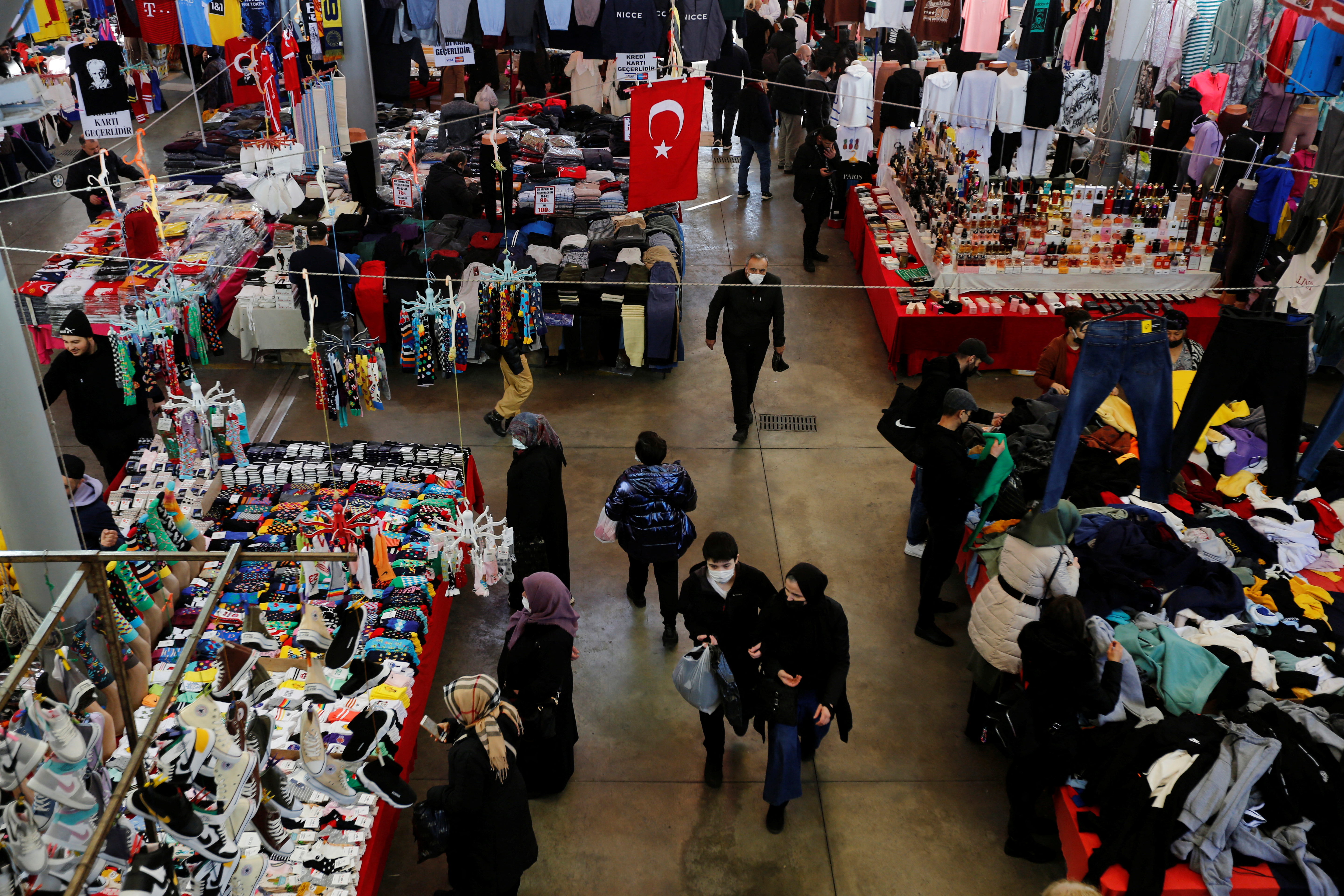 People shop at an open market in Istanbul