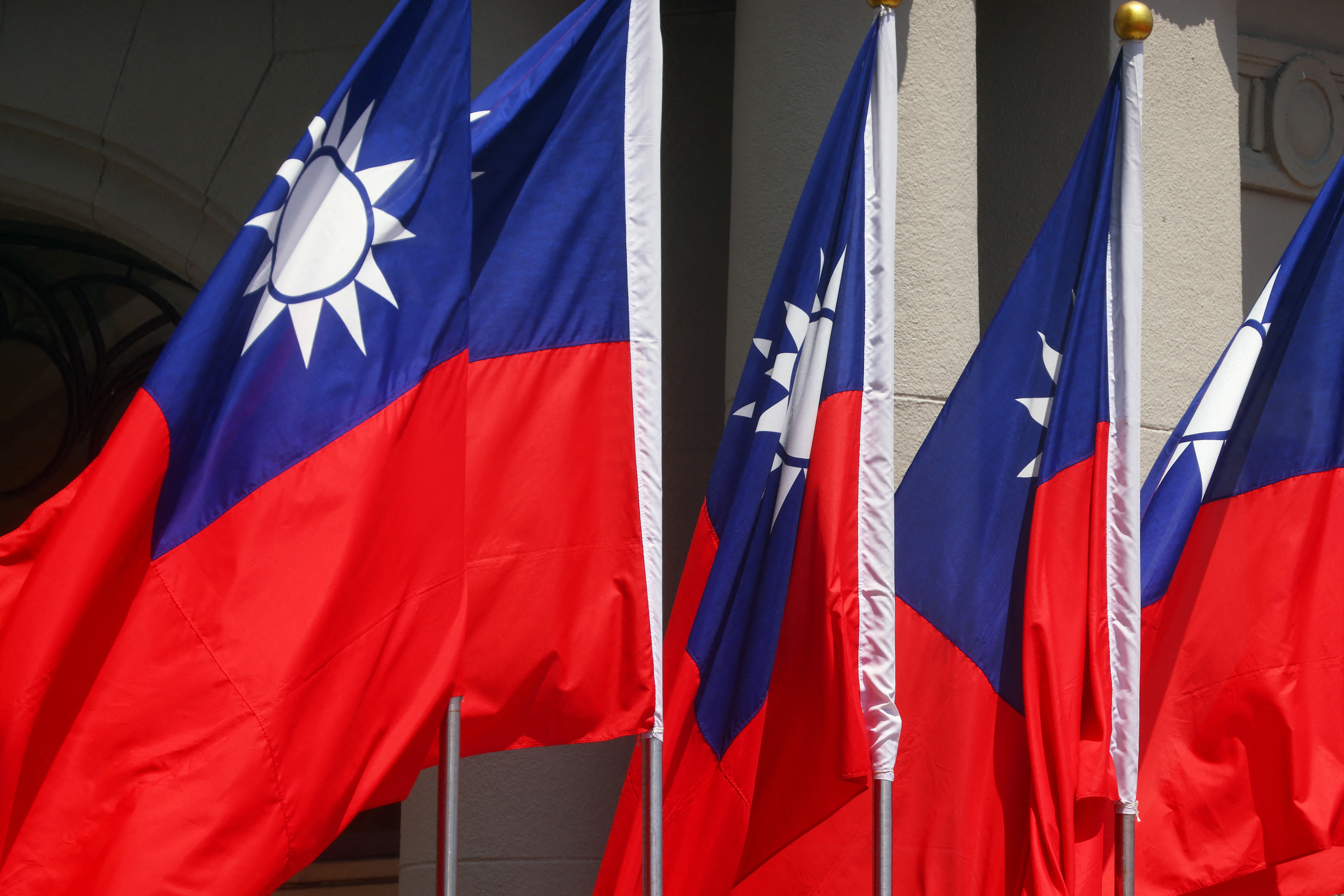 FILE PHOTO - Taiwan flags flutter during a welcome ceremony in Taipei