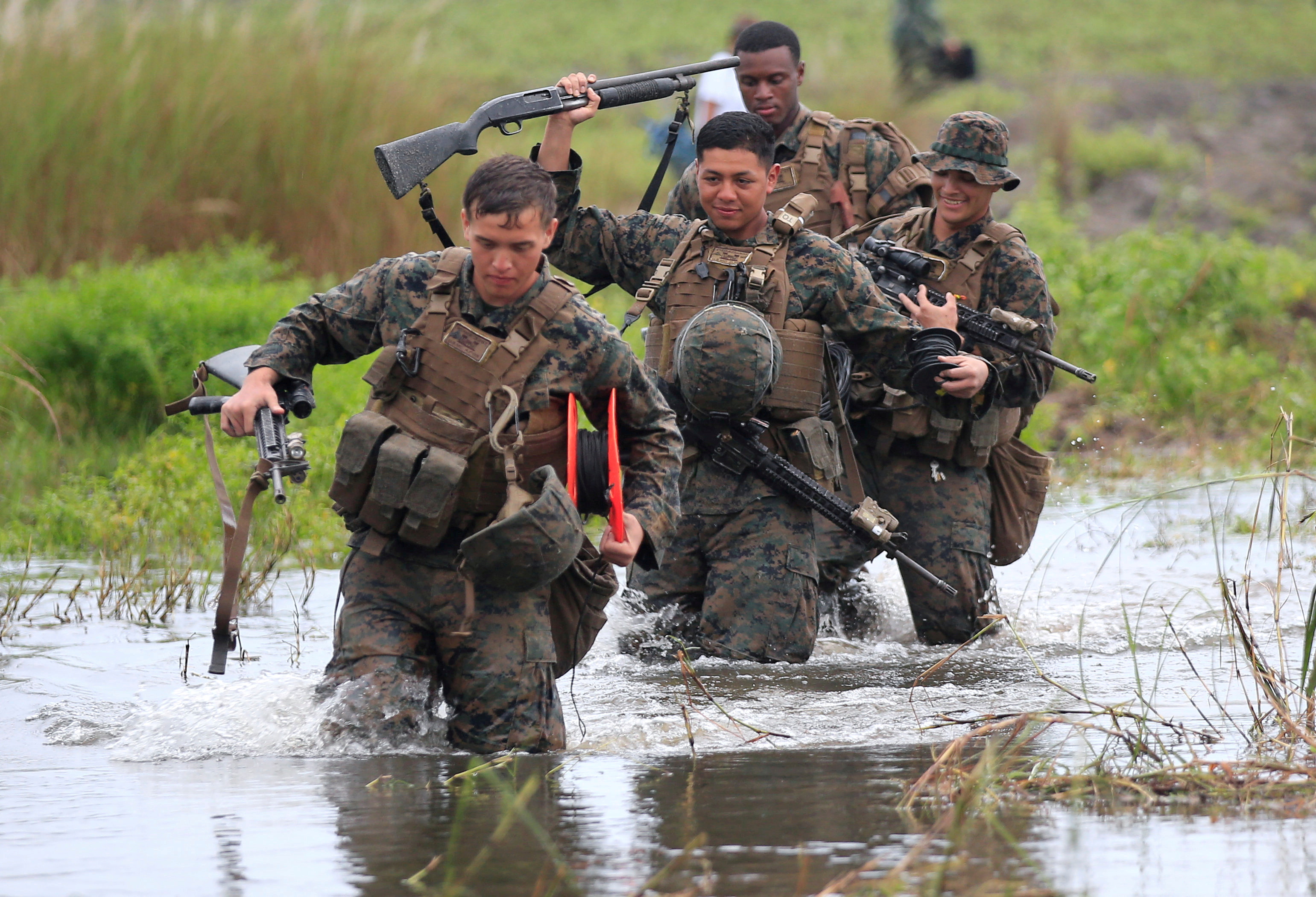 U.S. military forces cross a flooded area near the shore during the annual Philippines-US amphibious landing exercise (PHIBLEX) at San Antonio
