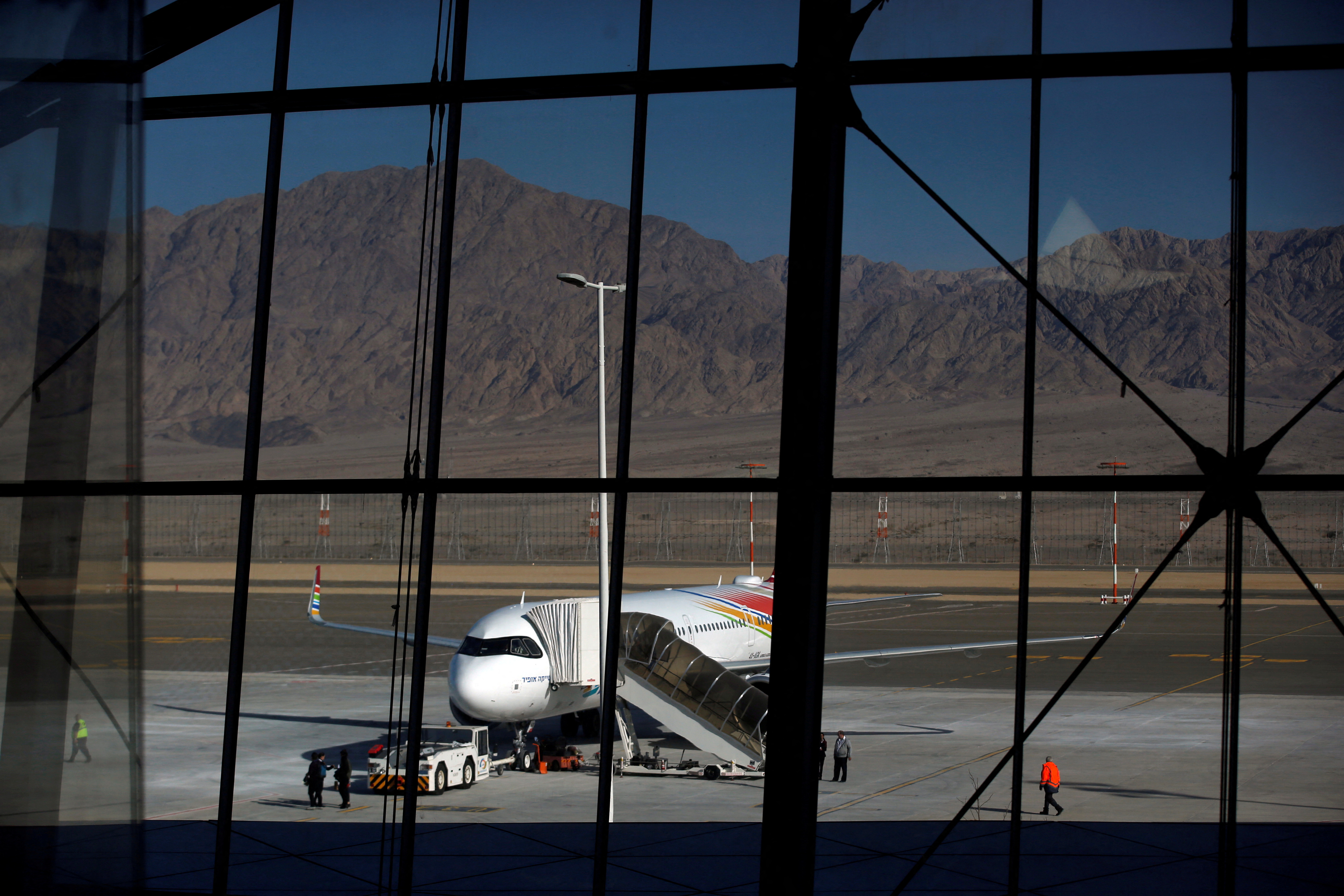 A plane is reflected in the facade of the Ramon International Airport after an inauguration ceremony for the new airport, just outside the southern Red Sea resort city of Eilat, Israel