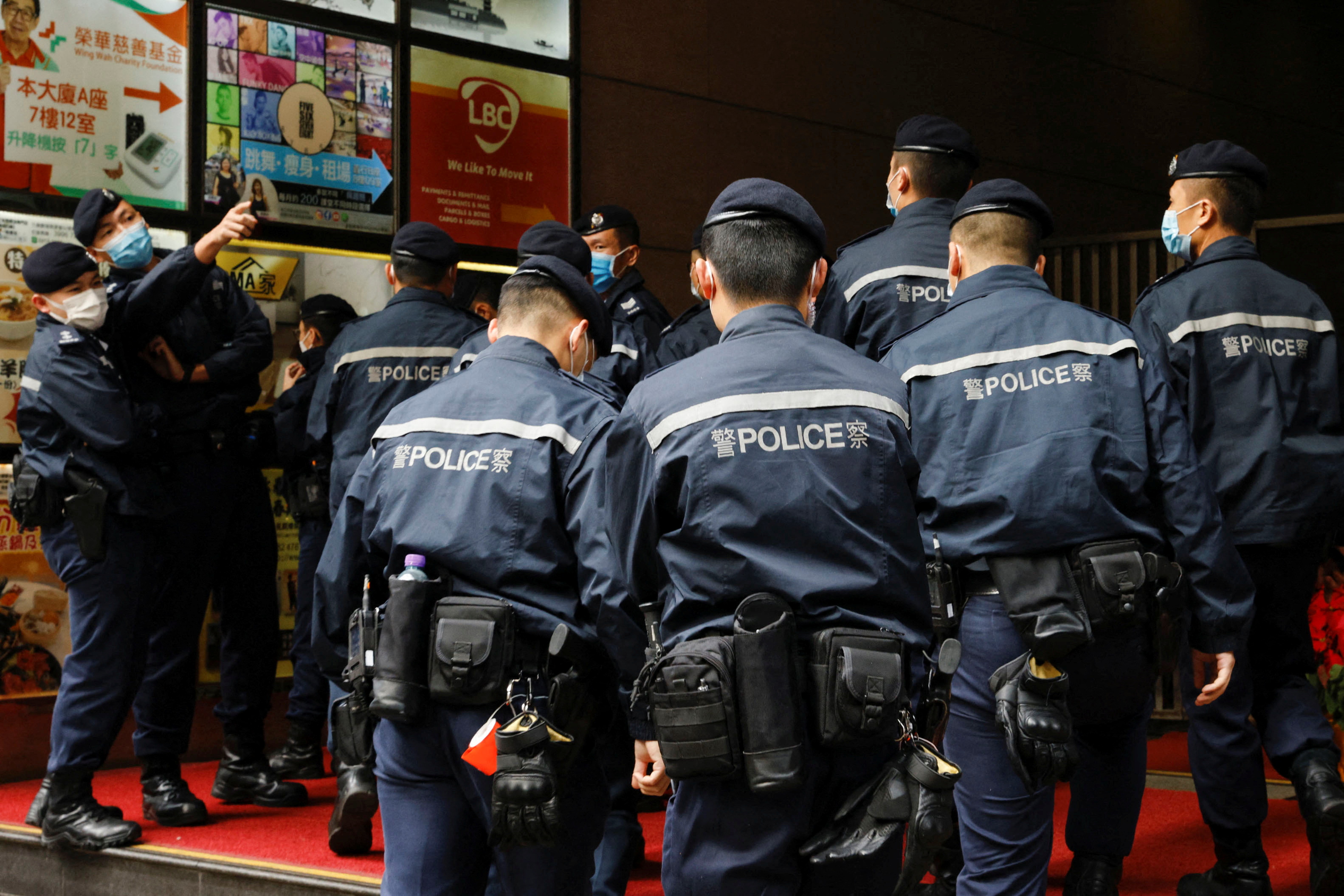 Police are seen outside the Stand News office building, after six people were arrested "for conspiracy to publish seditious publication" according to Hong Kong's Police National Security Department, in Hong Kong