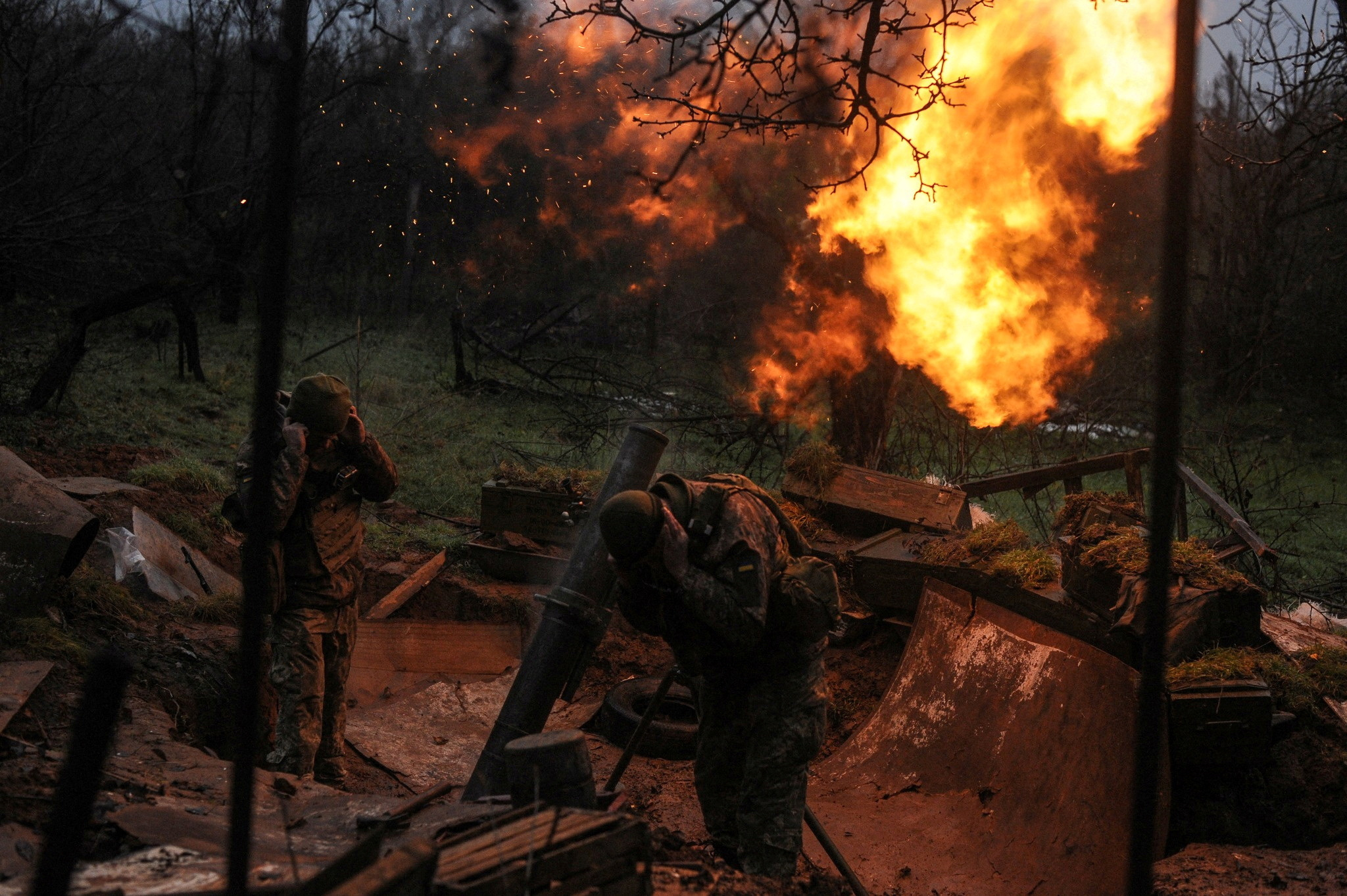 Ukrainian servicemen fire a mortar on a front line in Donetsk region