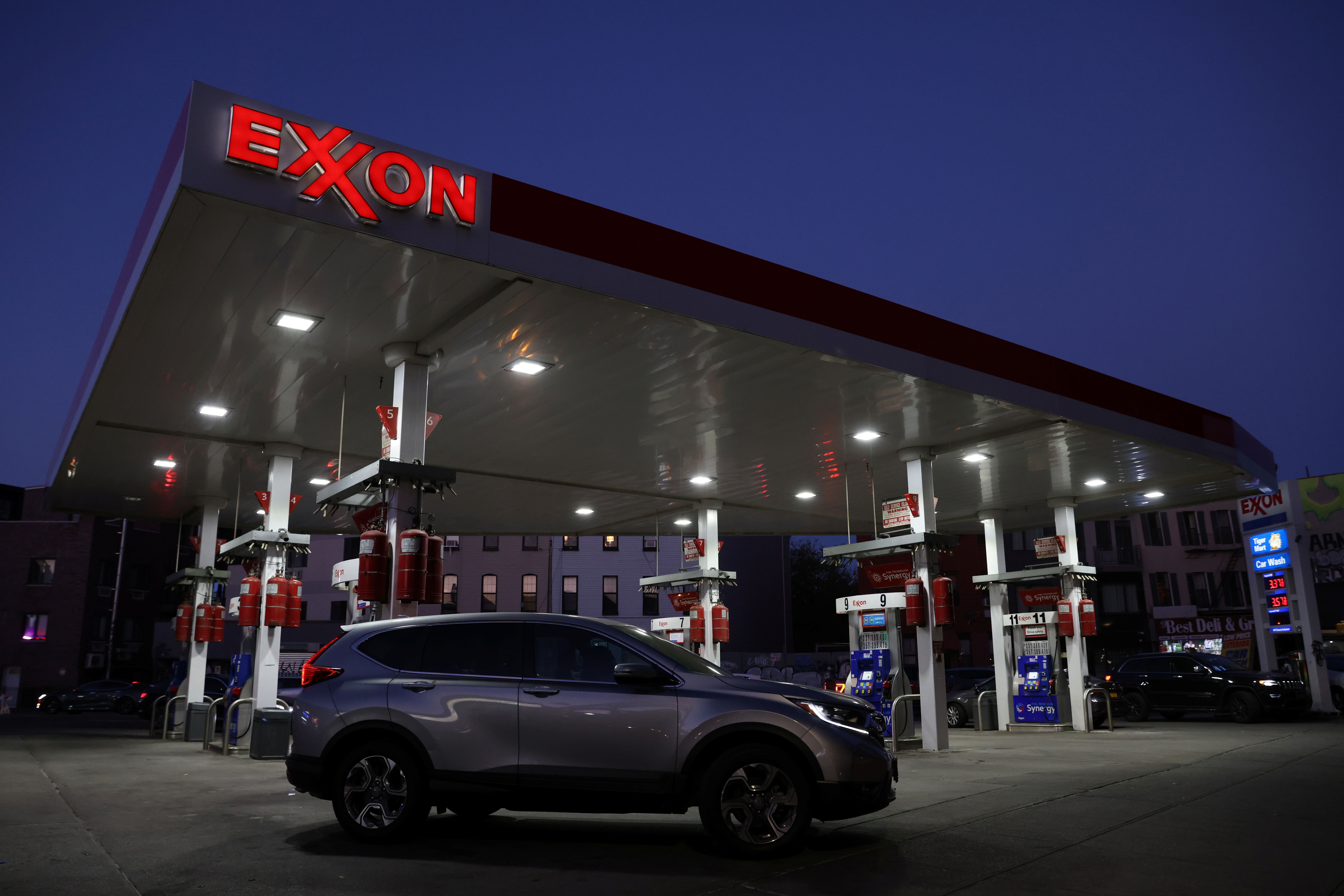 Cars are seen at an Exxon gas station in Brooklyn, New York City