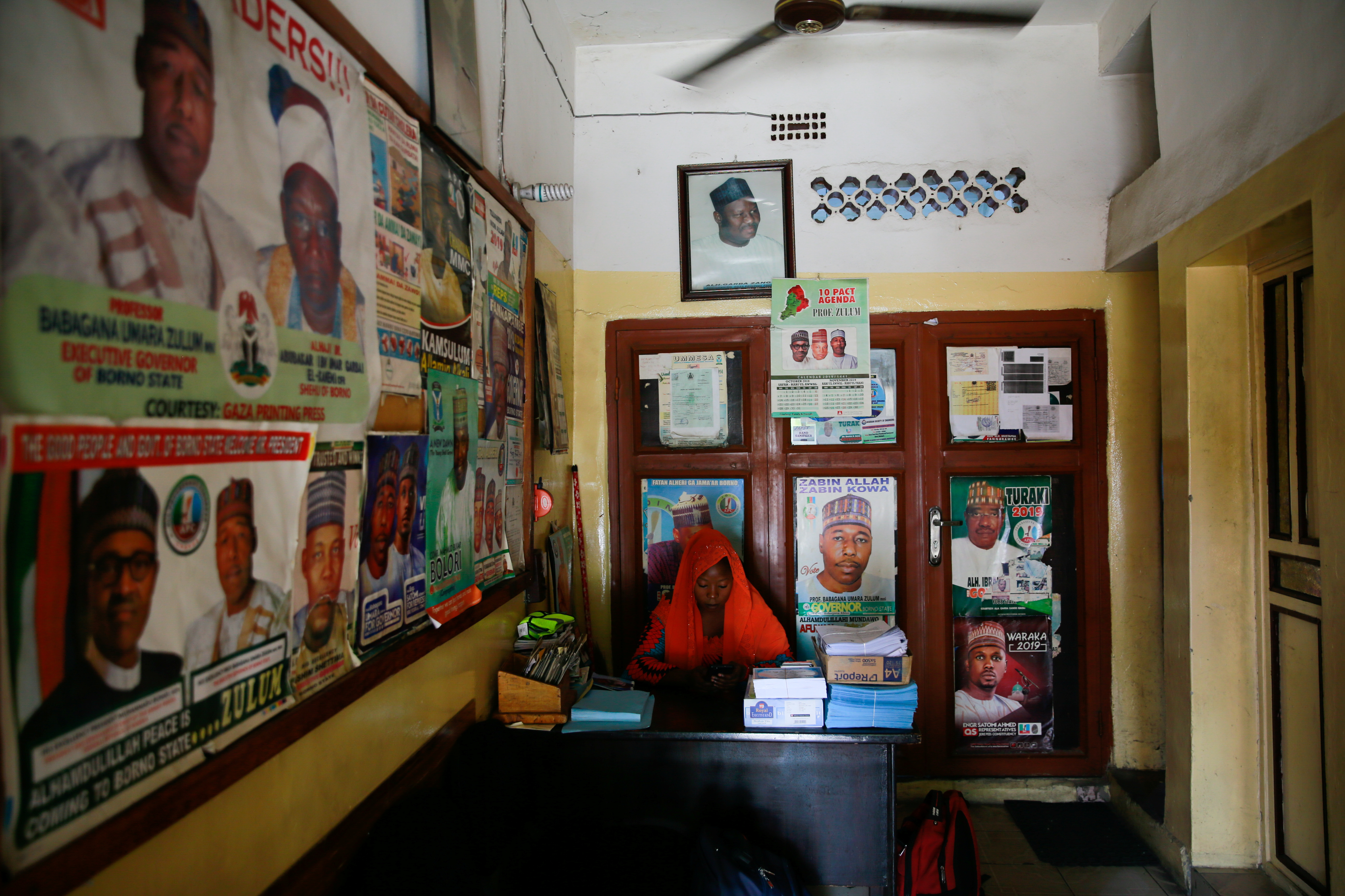 A receptionist works near Gaza printing press, in Maiduguri