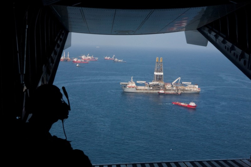 Crew member aboard US Coast Guard plane  looks over the Discoverer Enterprise drillship at site of Deepwater Horizon oil disaster off Louisiana coast