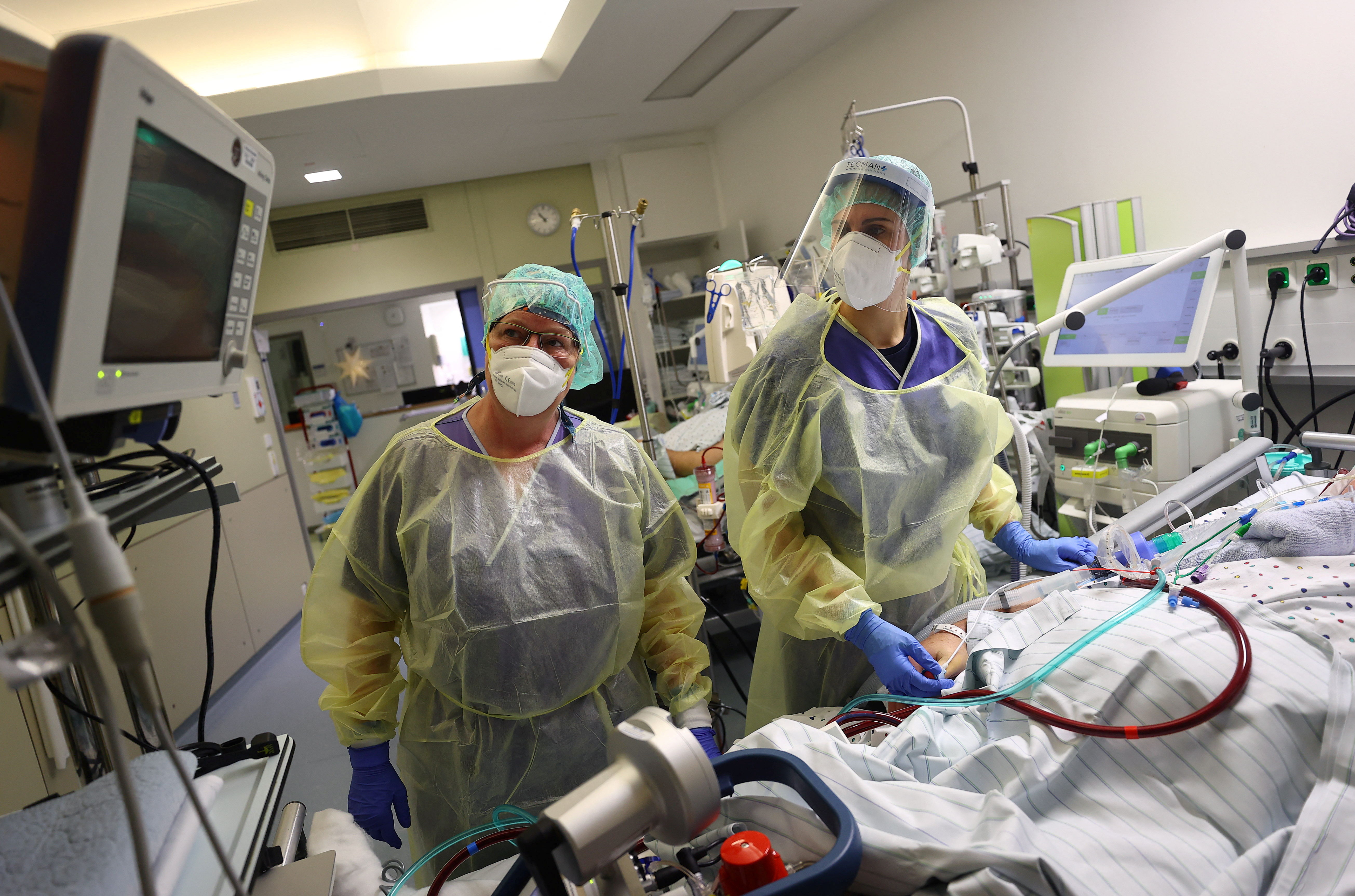 Medical staff adjust the ECMO (extracorporeal membrane oxygenation) life support unit before they transfer a patient for a CT examination at the coronavirus disease (COVID-19) Intensive Care Unit (ICU) of the 