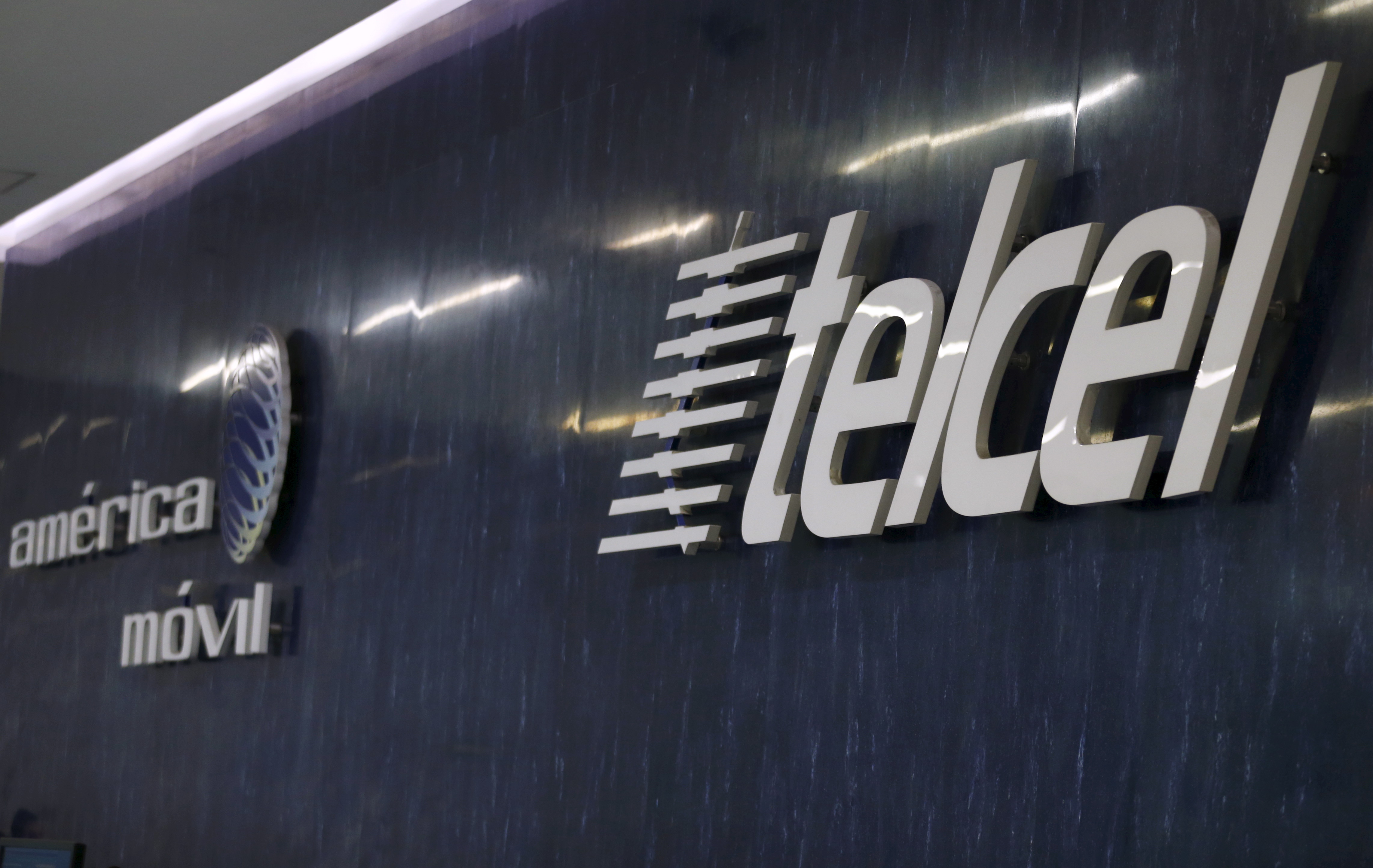 The logos of America Movil and its commercial brand Telcel are seen at the reception area in the company's offices in Mexico City