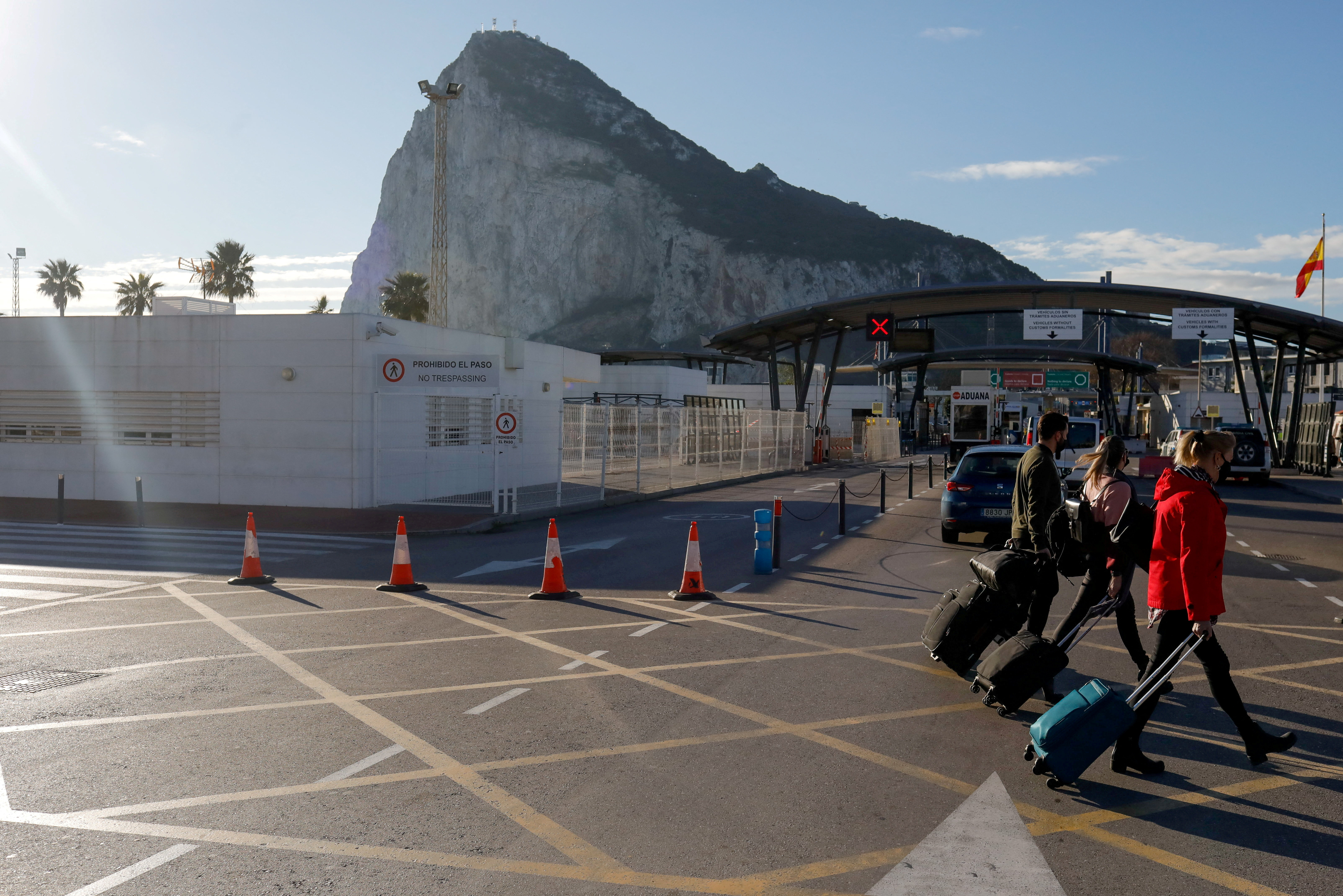 Tourists walk at the border between Spain and Gibraltar, in La Linea de la Concepcion