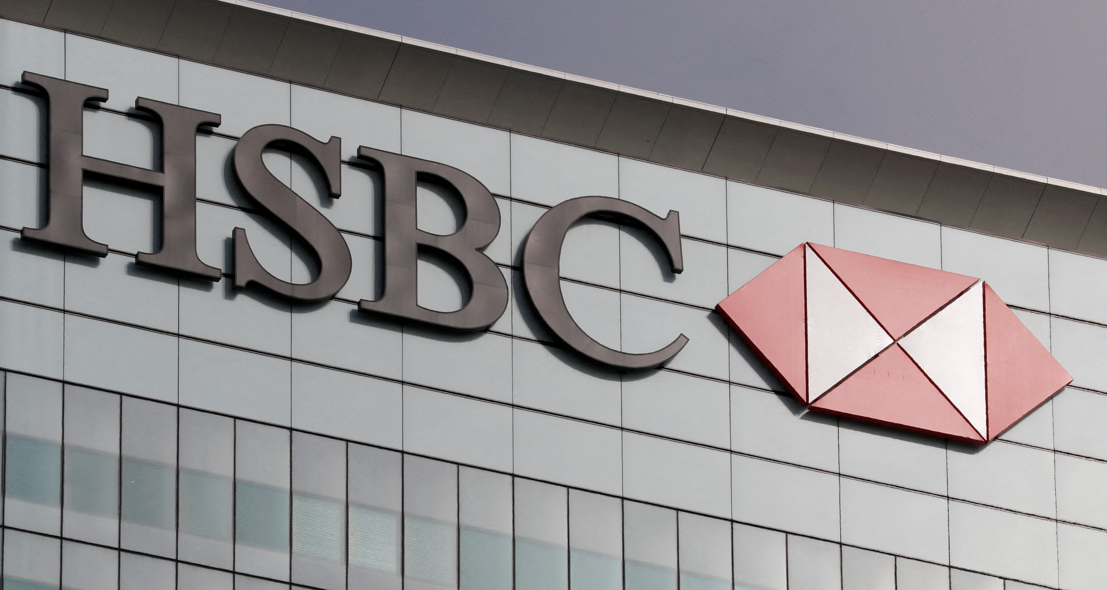 The HSBC logo is seen at its offices at Canary Wharf financial district in London