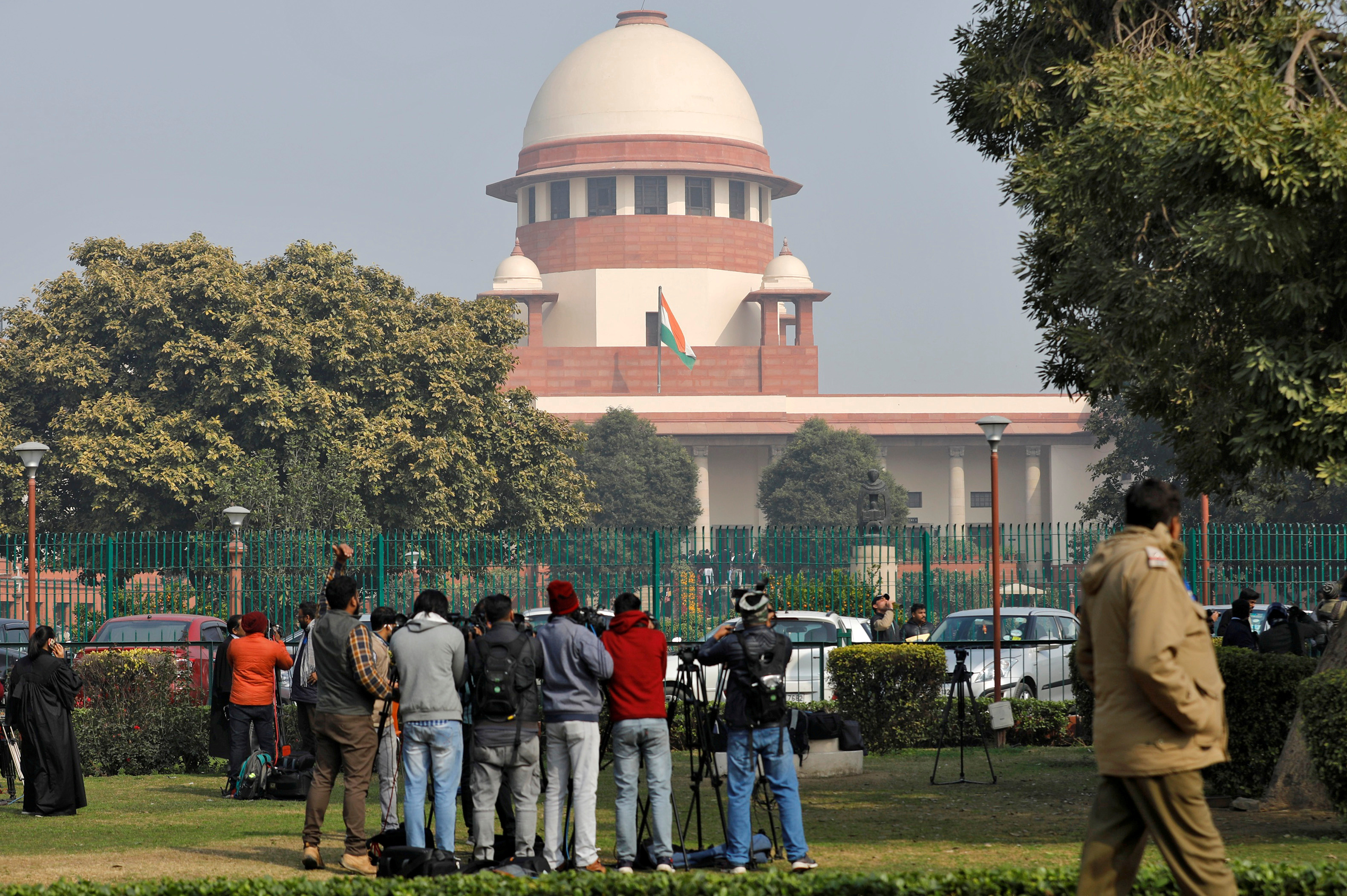 Television journalists are seen outside the premises of the Supreme Court in New Delhi