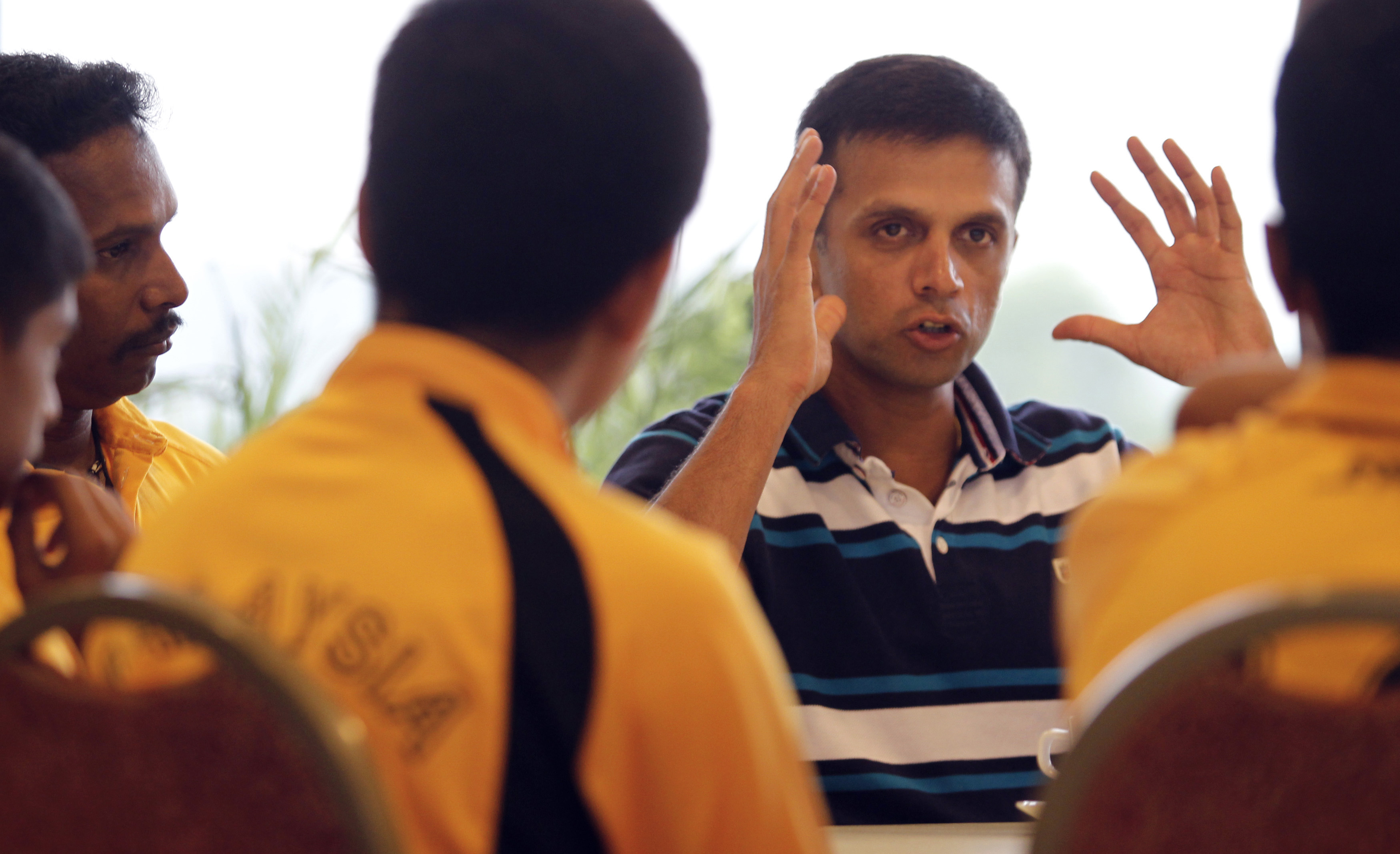 Former Indian cricket captain Rahul Dravid (R) speaks to Malaysian U-16 cricketers during a cricket clinic in Kuala Lumpur June 27, 2012. REUTERS/Bazuki Muhammad 