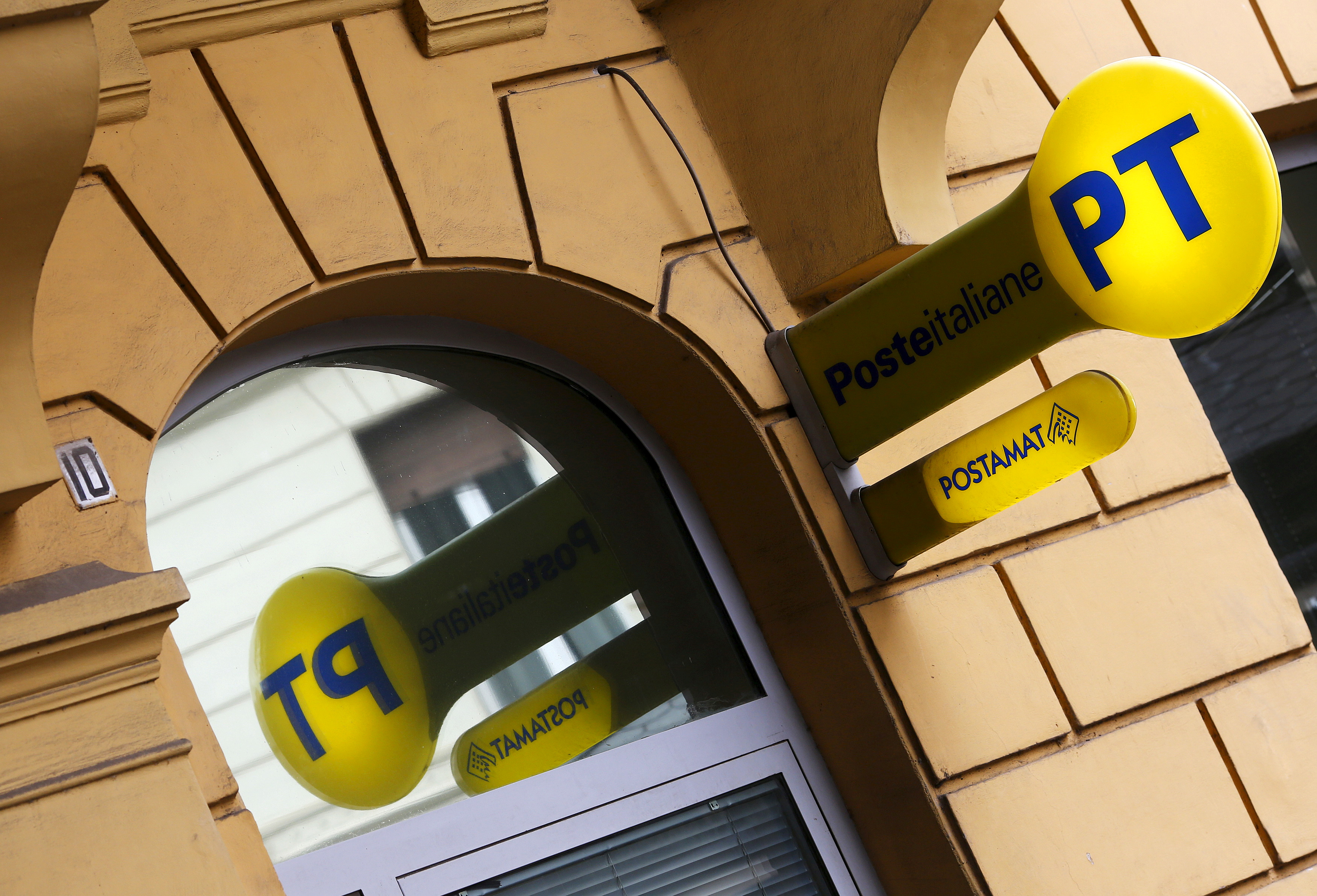 A signboard of Poste Italiane is seen hanging outside a post office in Rome