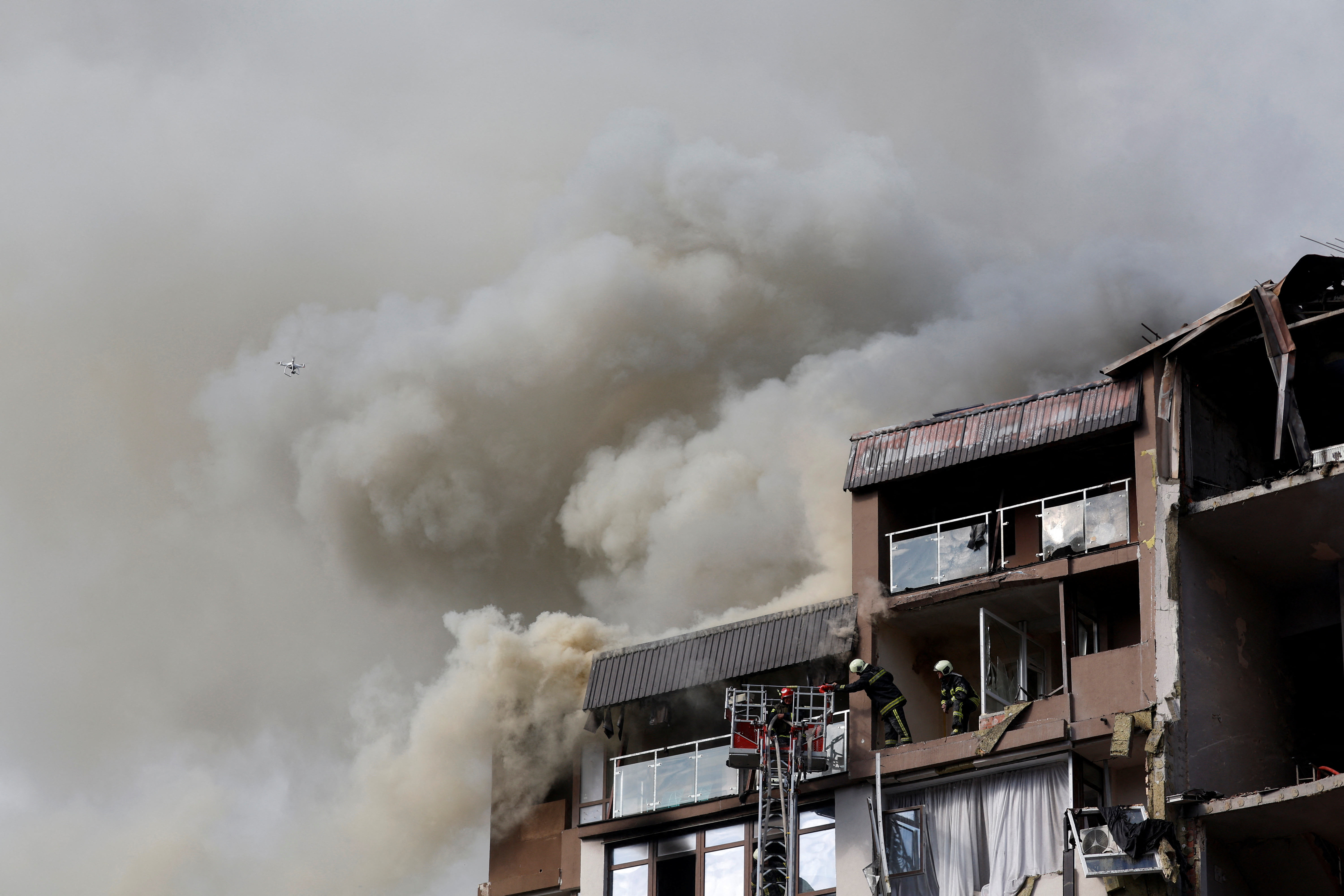 Smoke rises over a residential building damaged by a Russian missile strike, in Kyiv