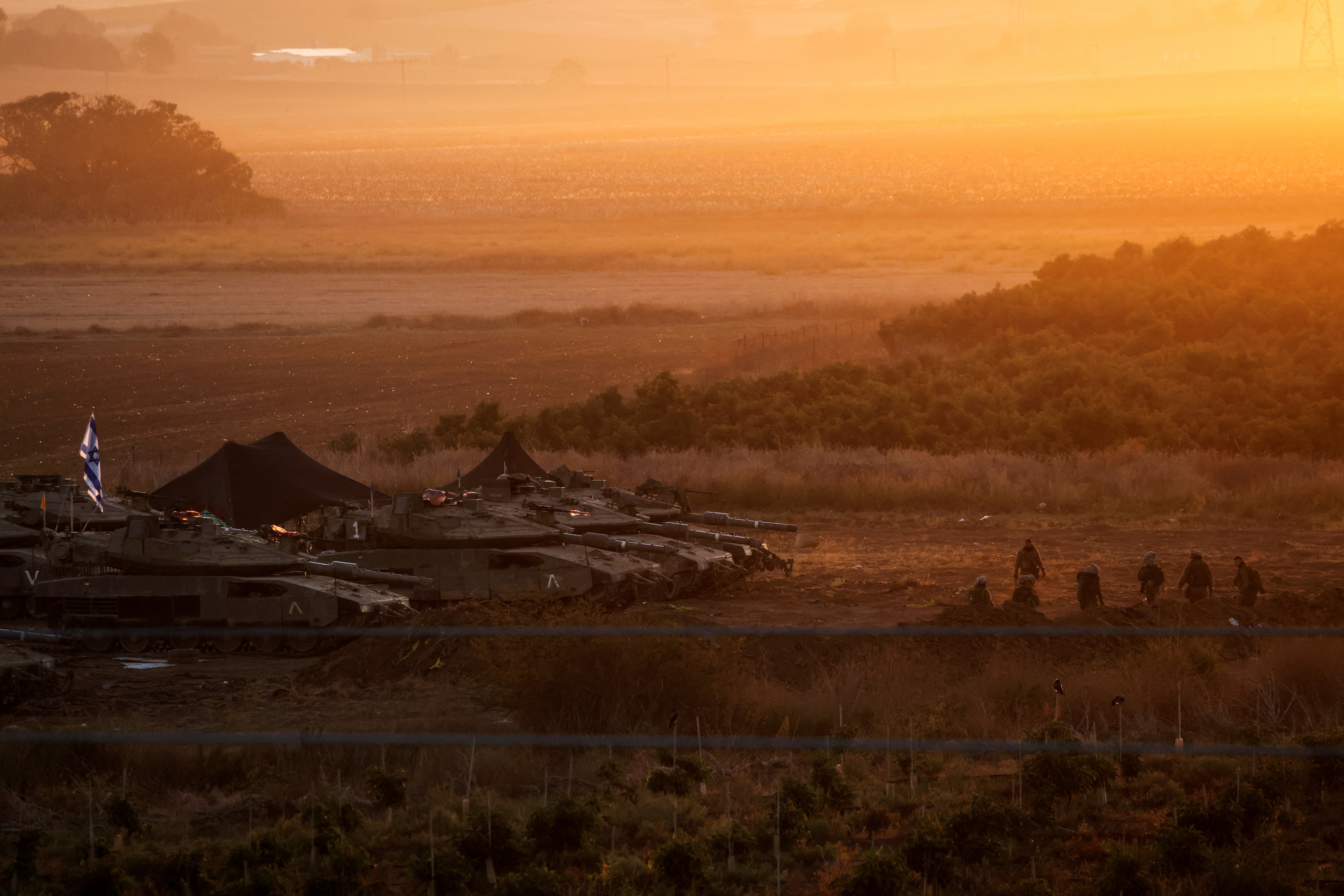 A formation of Israeli tanks is positioned near Israel's border with the Gaza Strip, in southern Israel