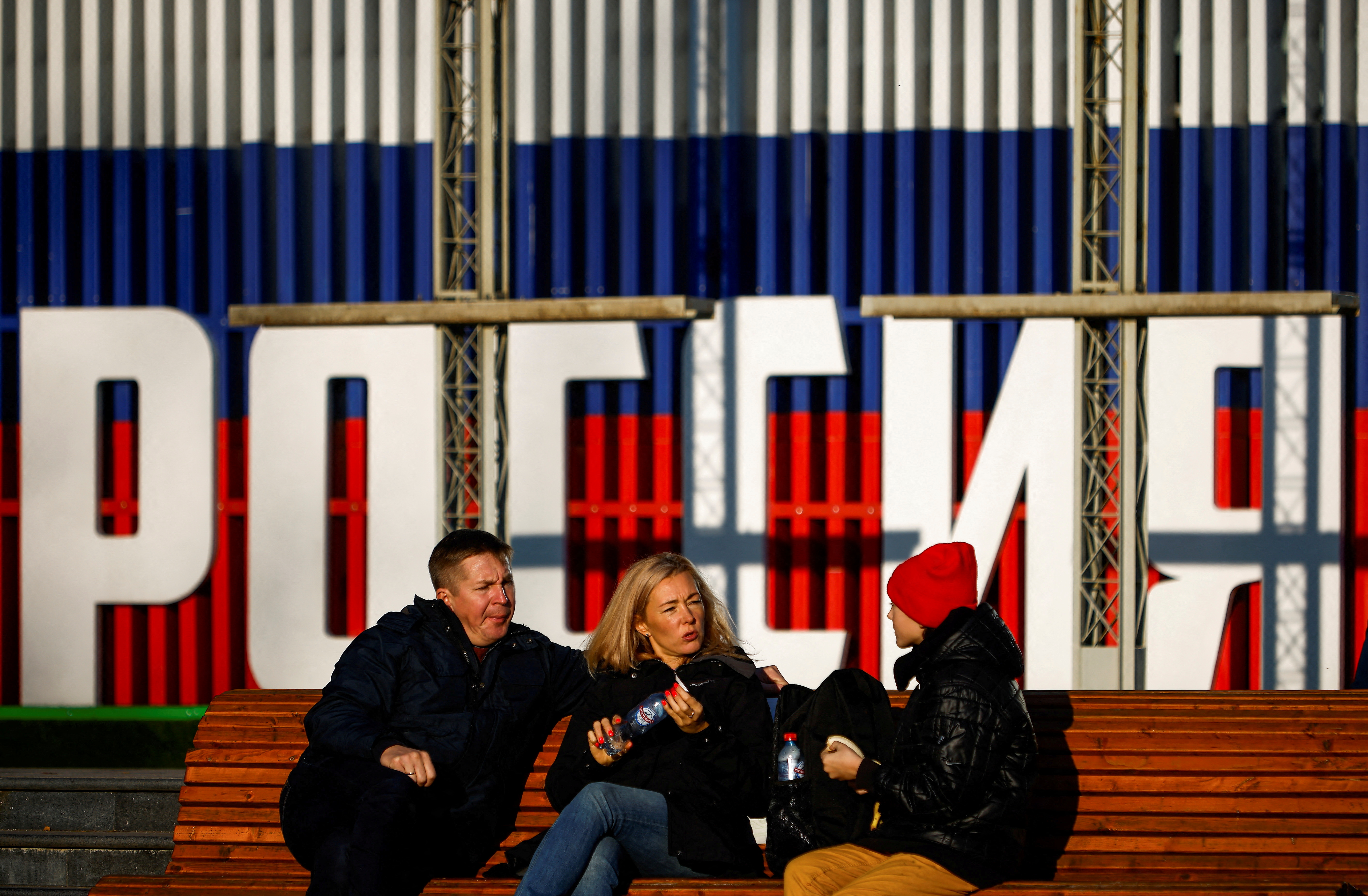 People rest on a bench in Moscow