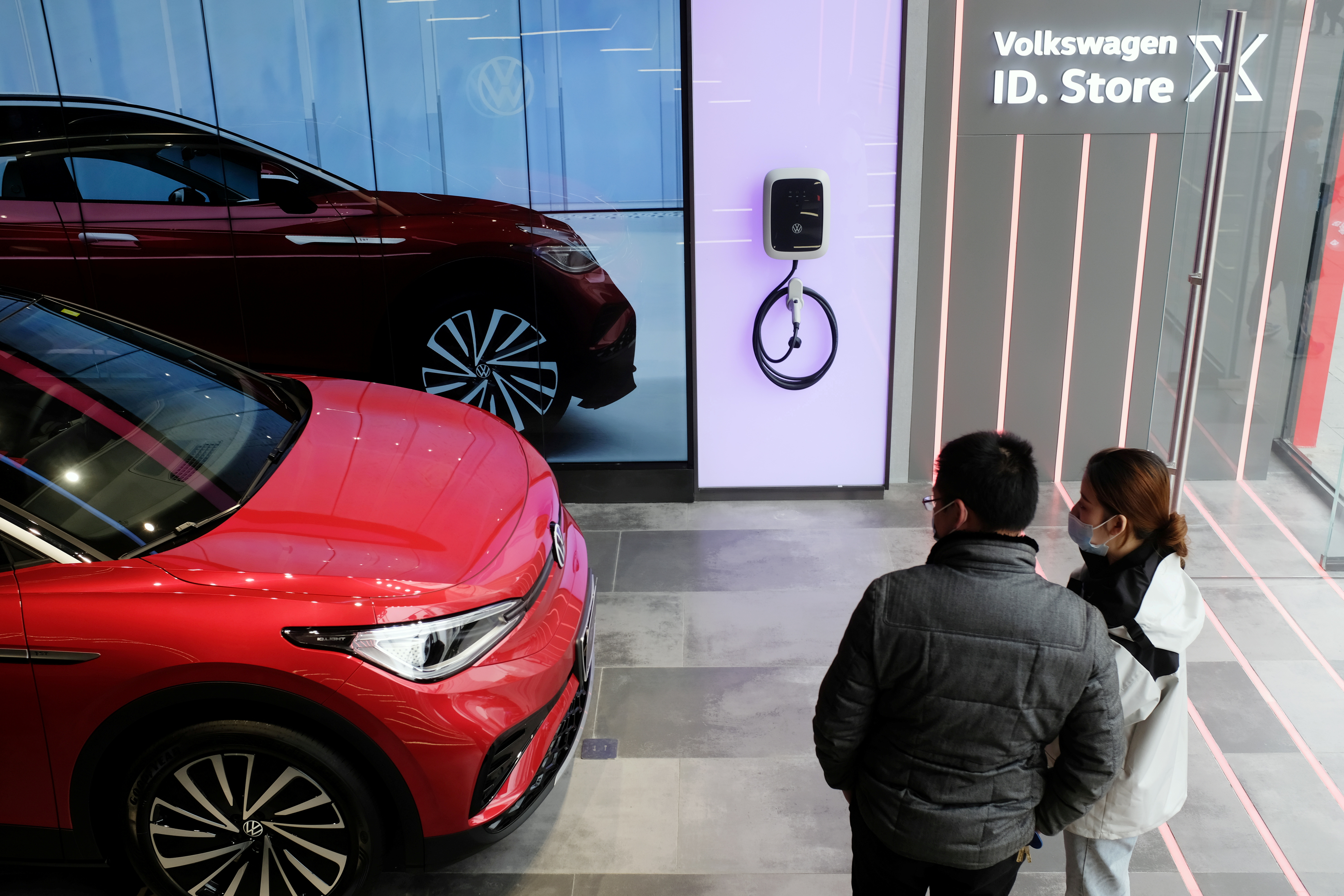 People check a Volkswagen ID.4 X electric vehicle inside an ID. Store X showroom of SAIC Volkswagen in Chengdu