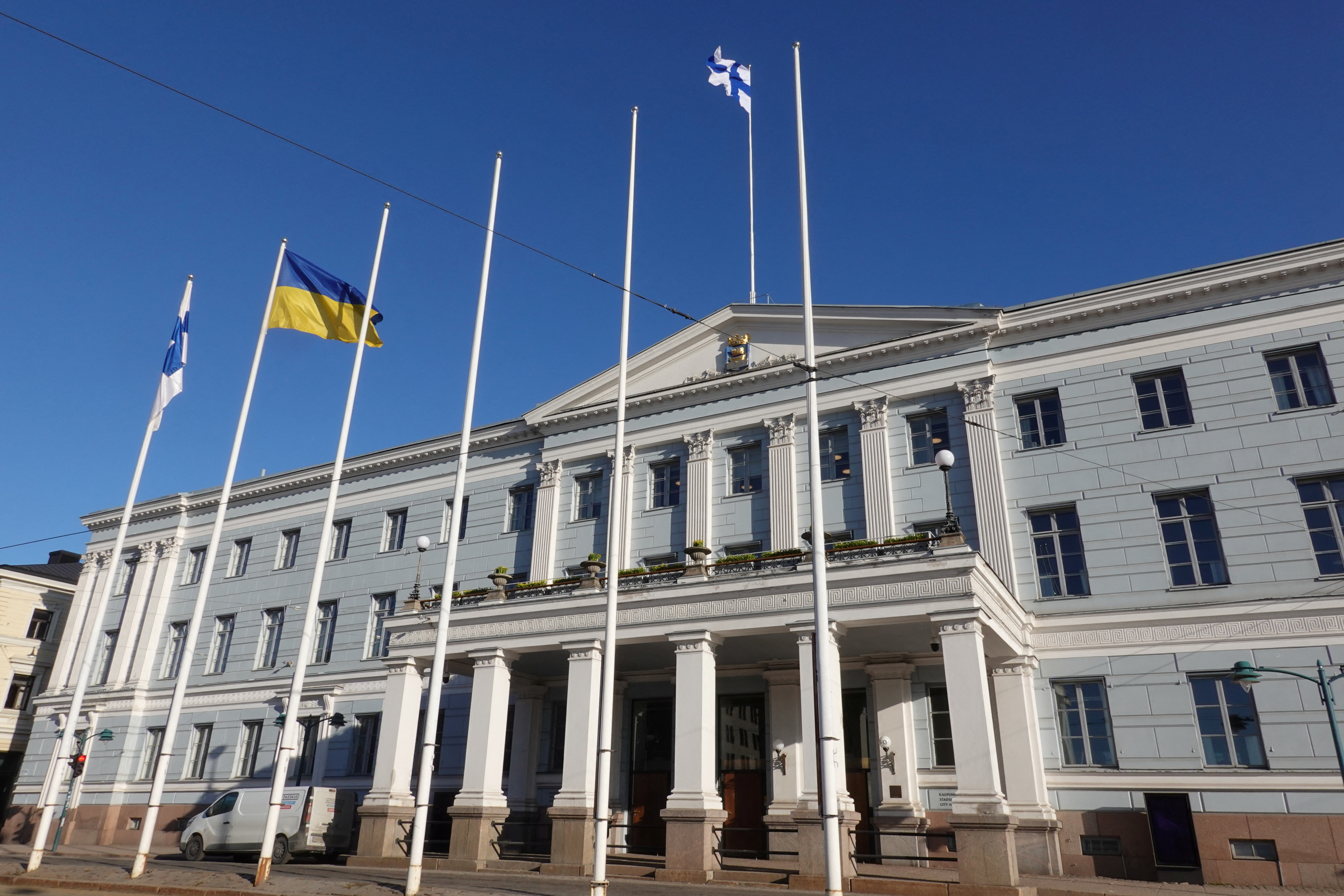 The Finnish and Ukrainian flags flutter outside the city hall, as Finland becomes a member of NATO, in Helsinki