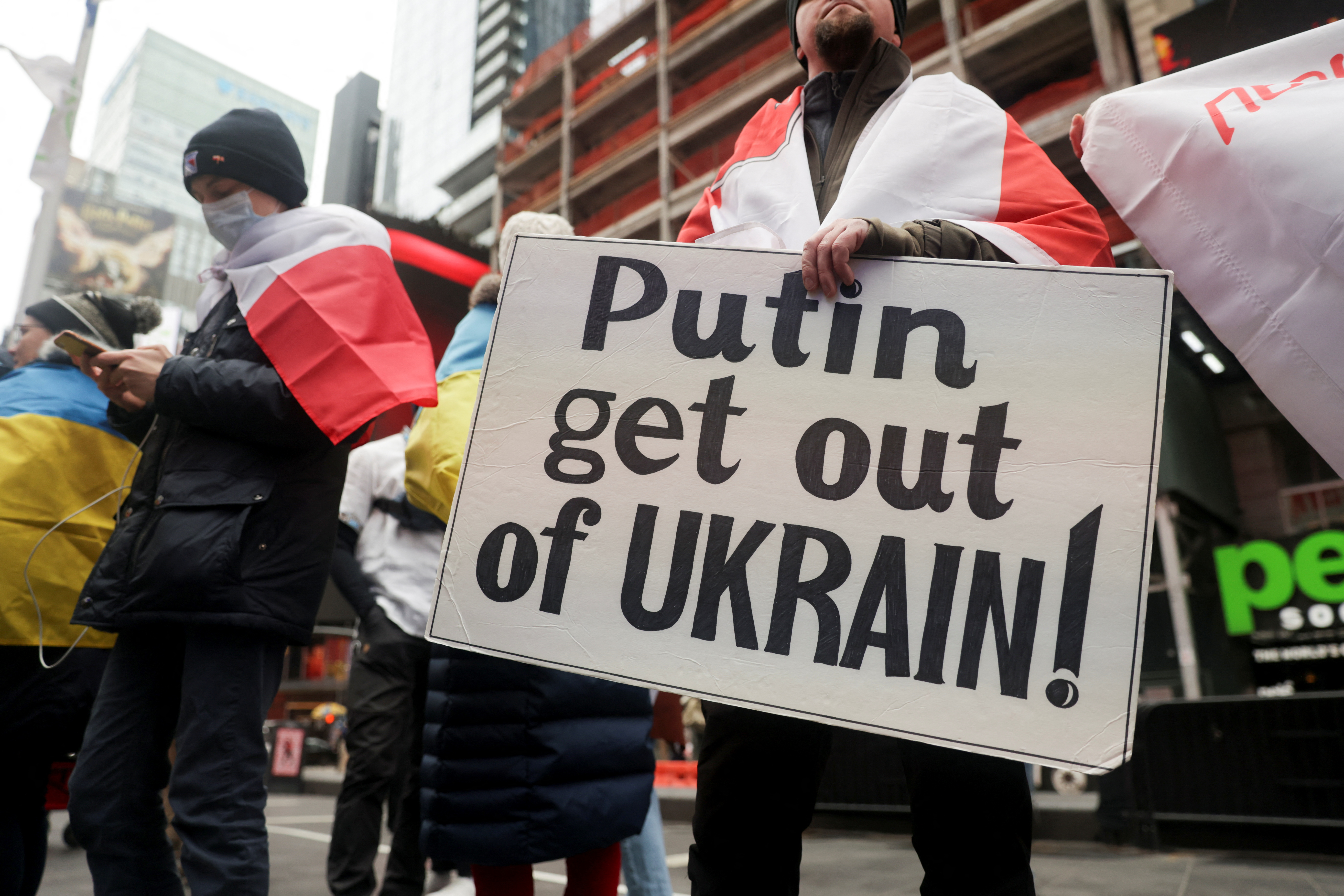 People take part in a protest against Russia's military operation in Ukraine, in Times Square, in New York City, U.S., February 24, 2022. REUTERS/Jeenah Moon