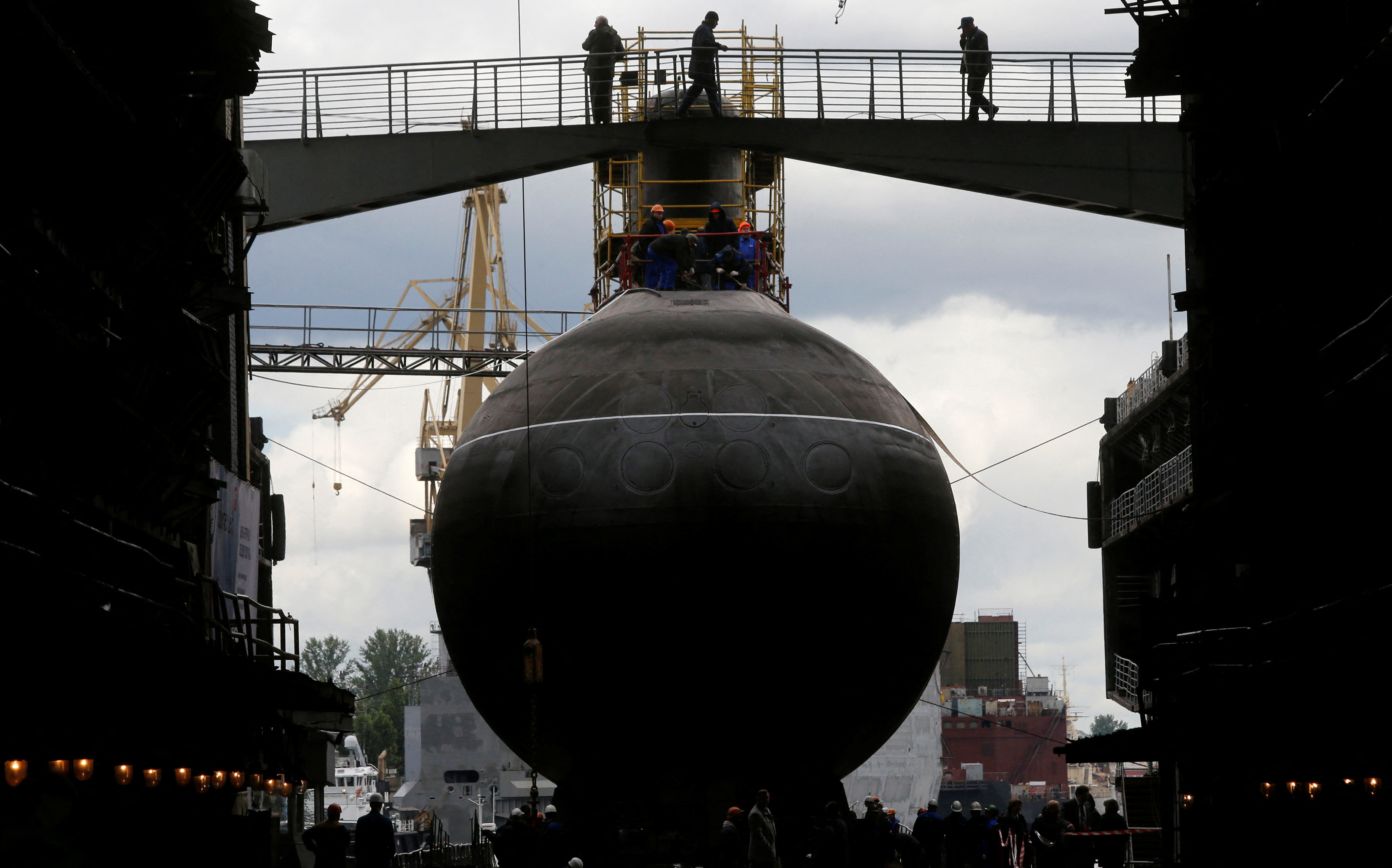 People attend a ceremony launching the diesel-electric submarine "Rostov-on-Don" at the Admiralty Shipyards in St. Petersburg