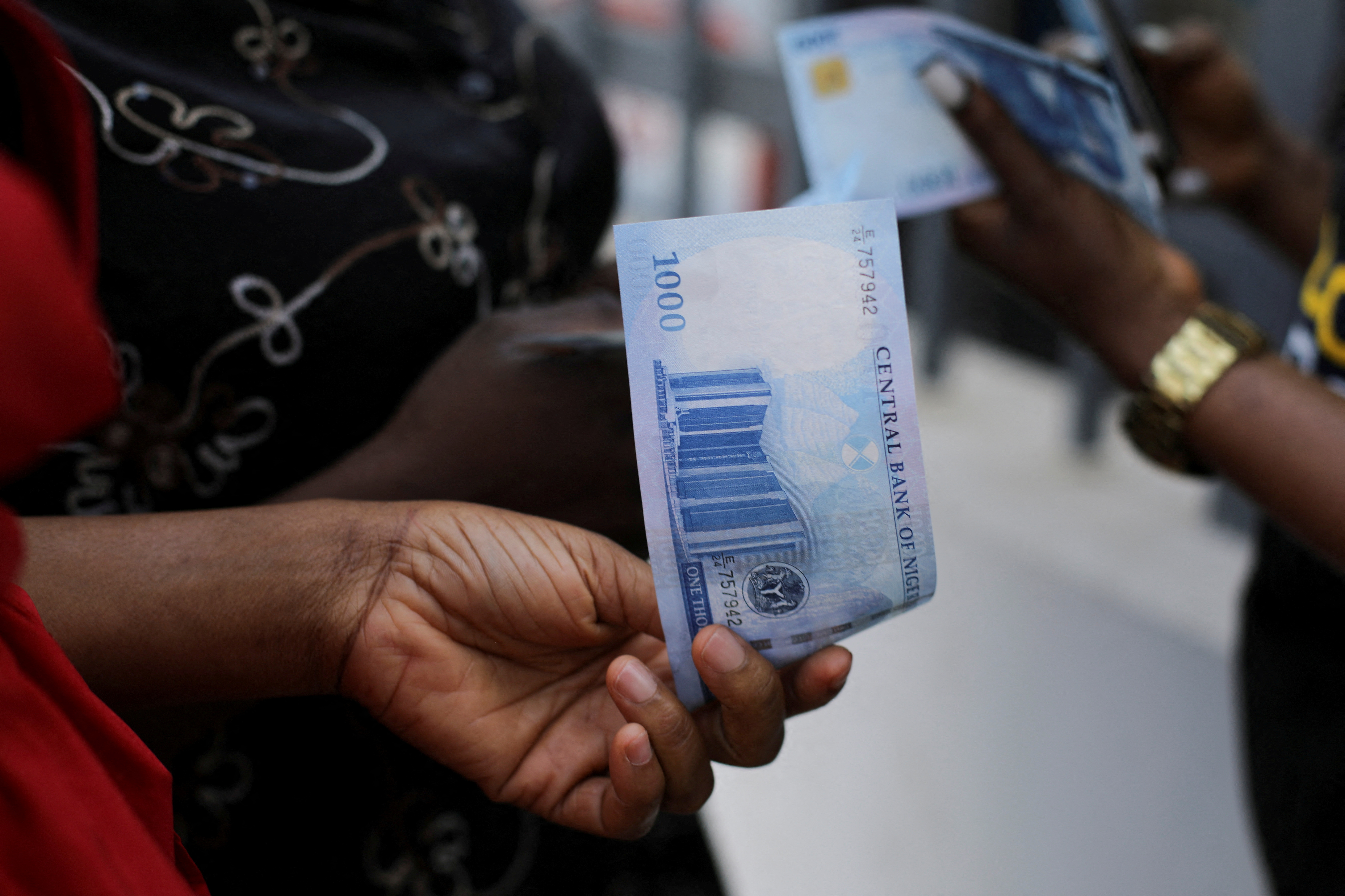 A person holds a new 1000 Naira note as the Central Bank of Nigeria releases the notes to the public through the banks in Abuja