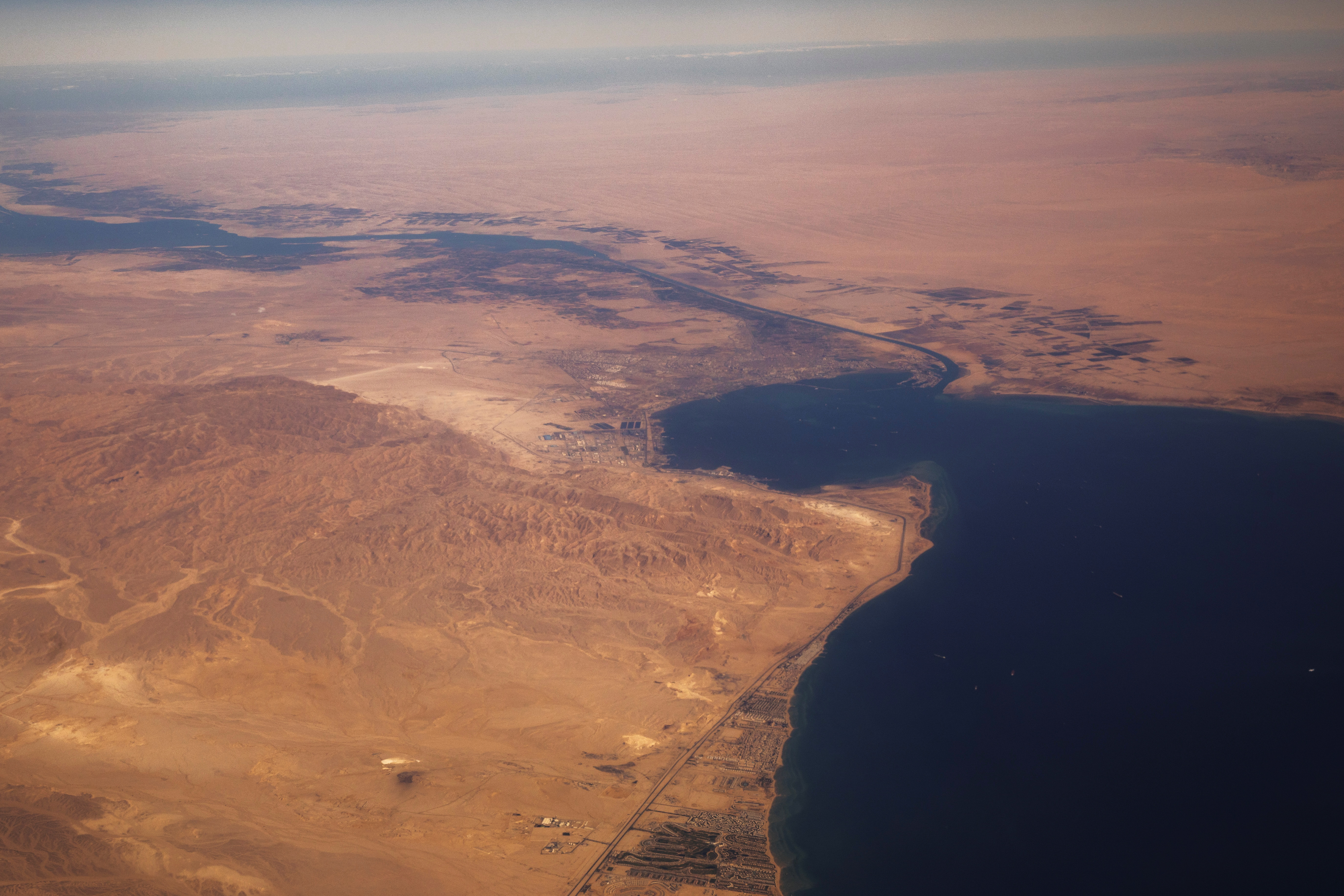 The Suez Canal connecting the Mediterranean Sea to the Red Sea is pictured from the window of a commercial plane flying over Egypt
