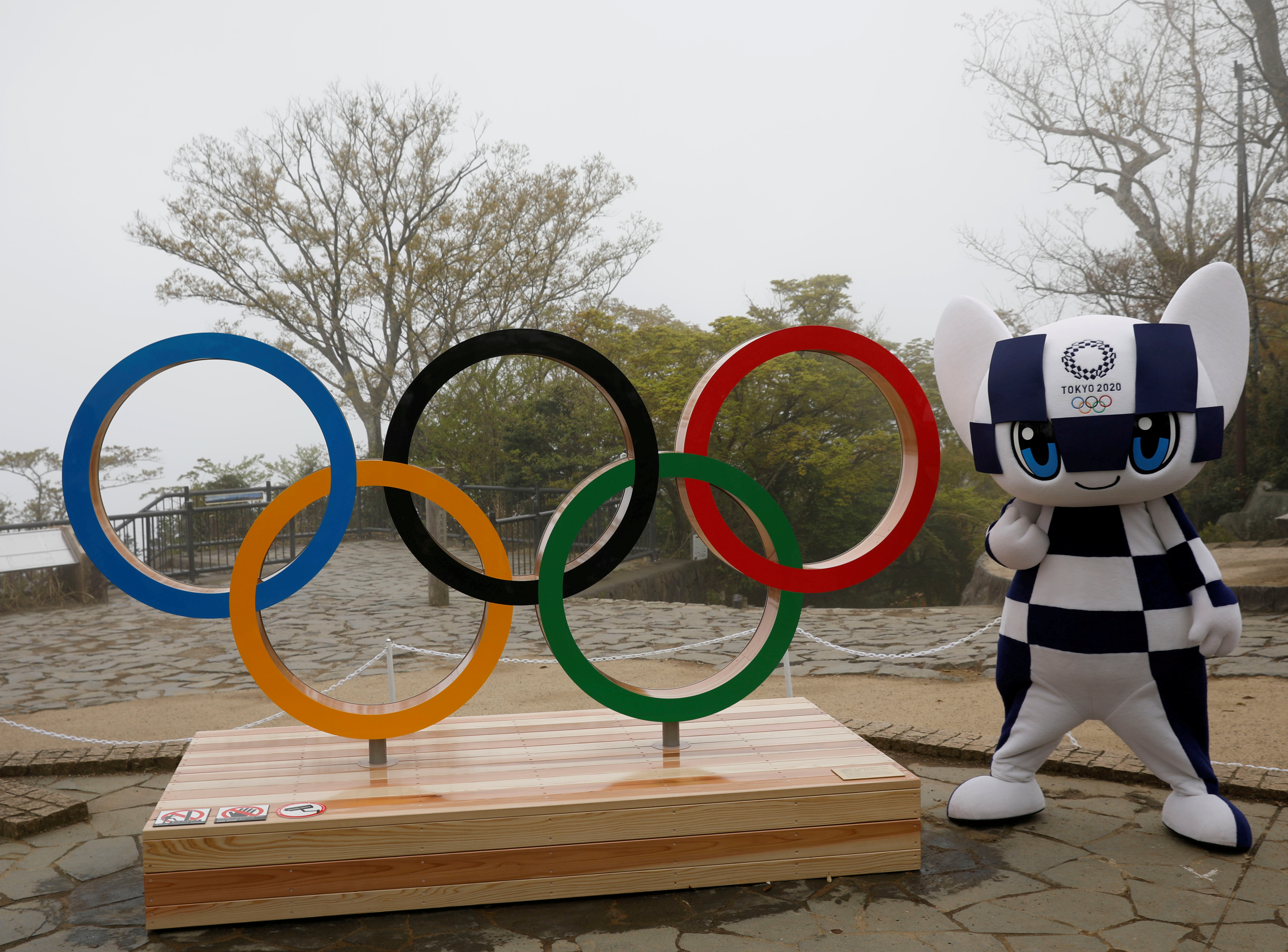 Tokyo 2020 Olympic Games mascot Miraitowa poses with a display of the Olympic symbol after an unveiling ceremony of the symbol on Mt. Takao in Hachioji, west of Tokyo, Japan, April 14, 2021. REUTERS/Kim Kyung-Hoon/Pool