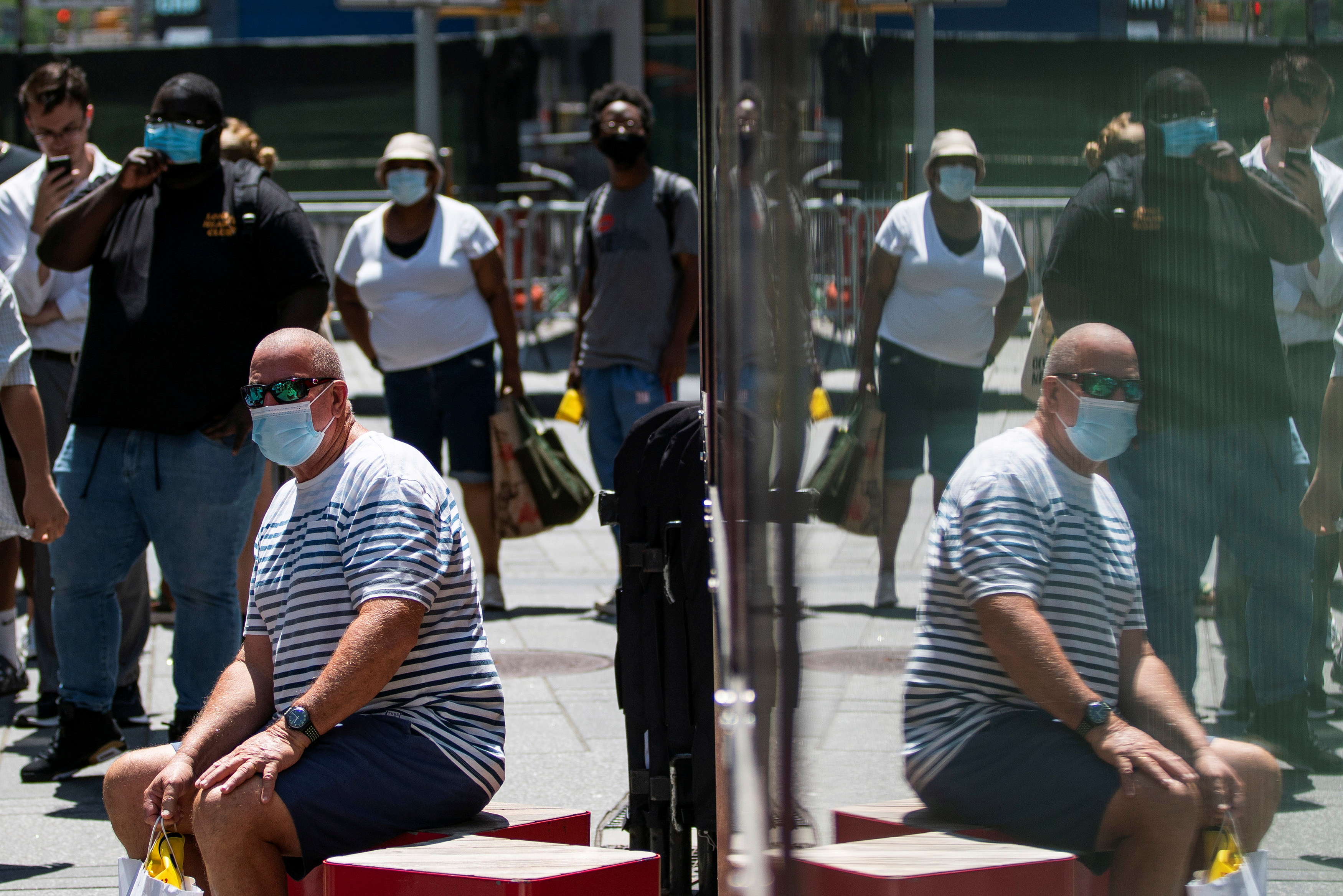 People wear masks to prevent against the spread of the coronavirus disease (COVID-19) in New York