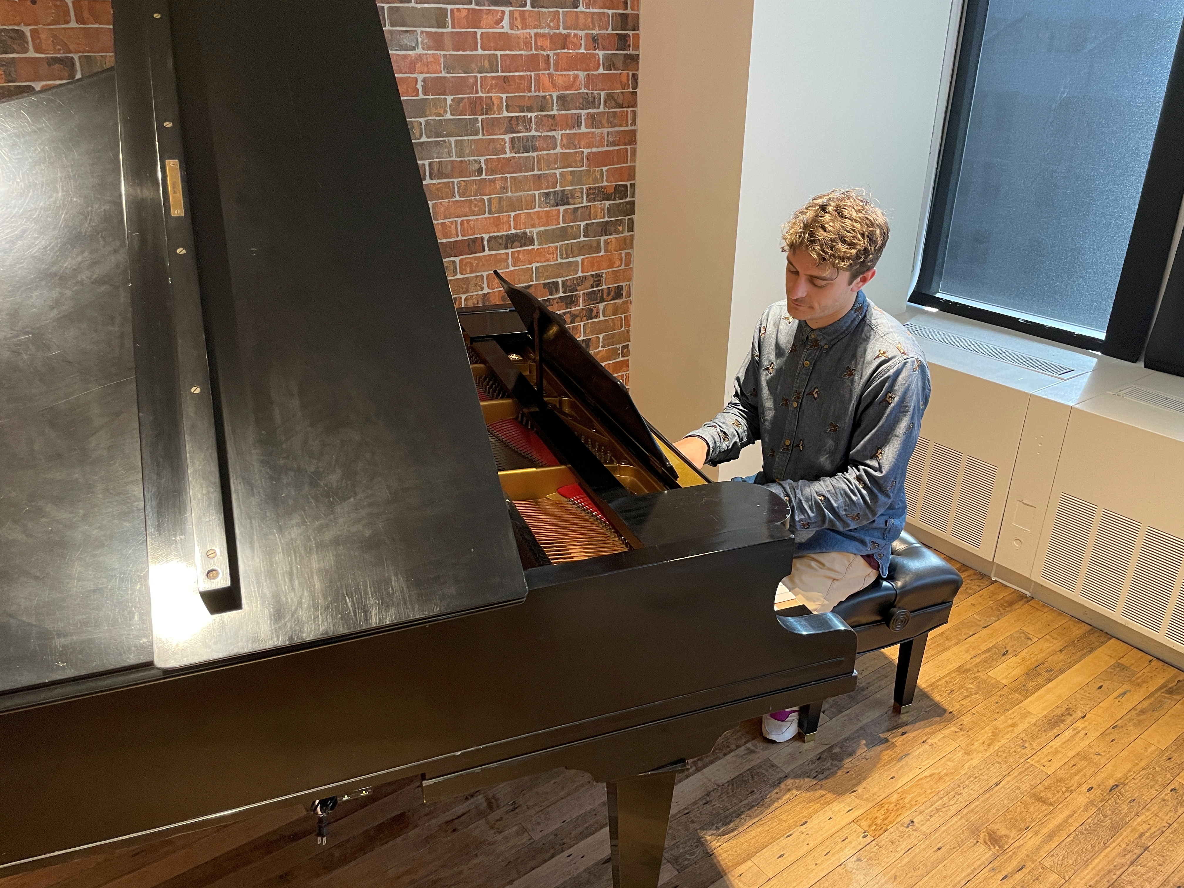 Jakub Jozef Orlinski, opera singer and breakdance performer, plays piano at the Warner Music offices in New York City