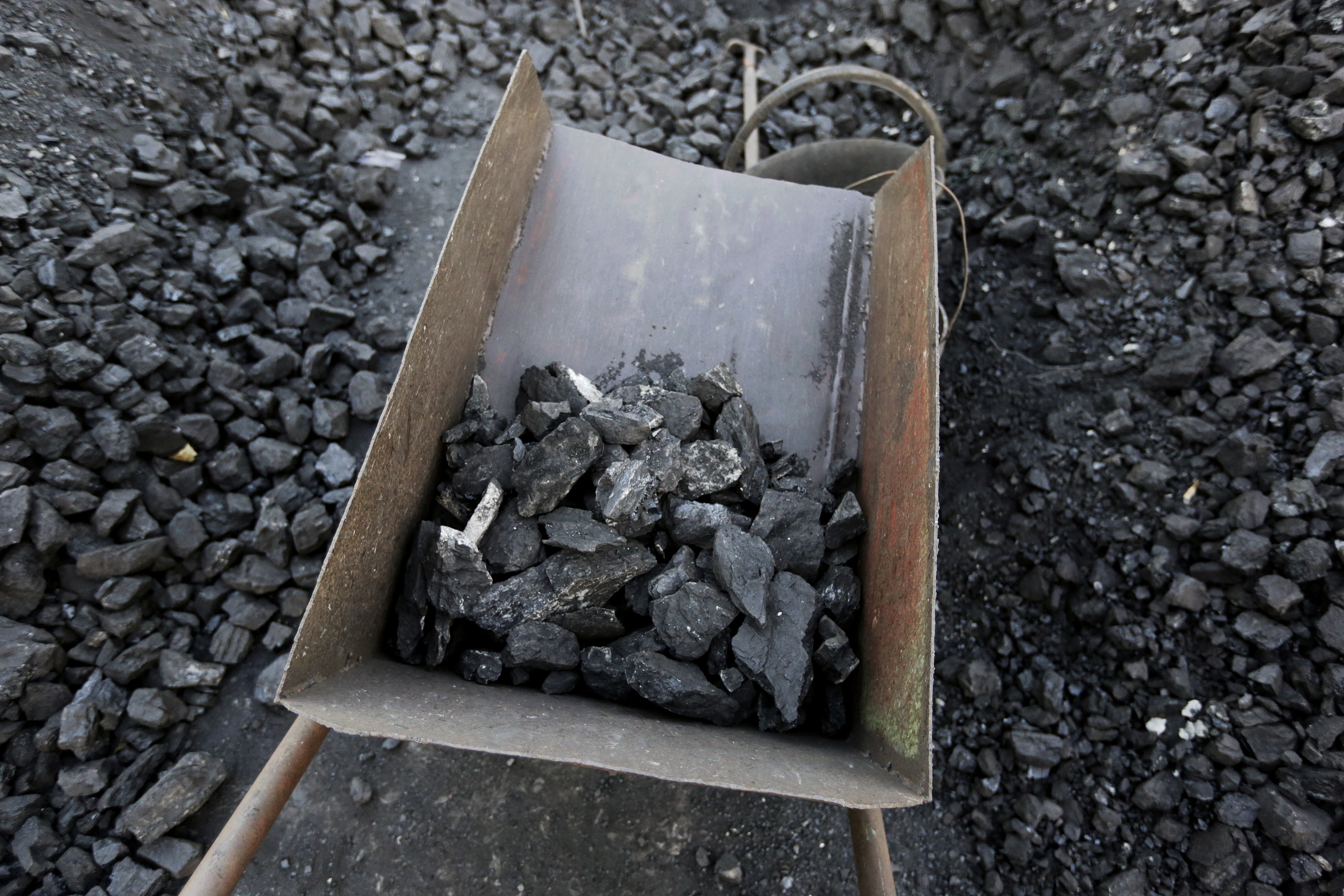 Bad quality coal is picked out at local businessman Sun Meng's small coal depot near a coal mine of the state-owned Longmay Group on the outskirts of Jixi, Heilongjiang, China