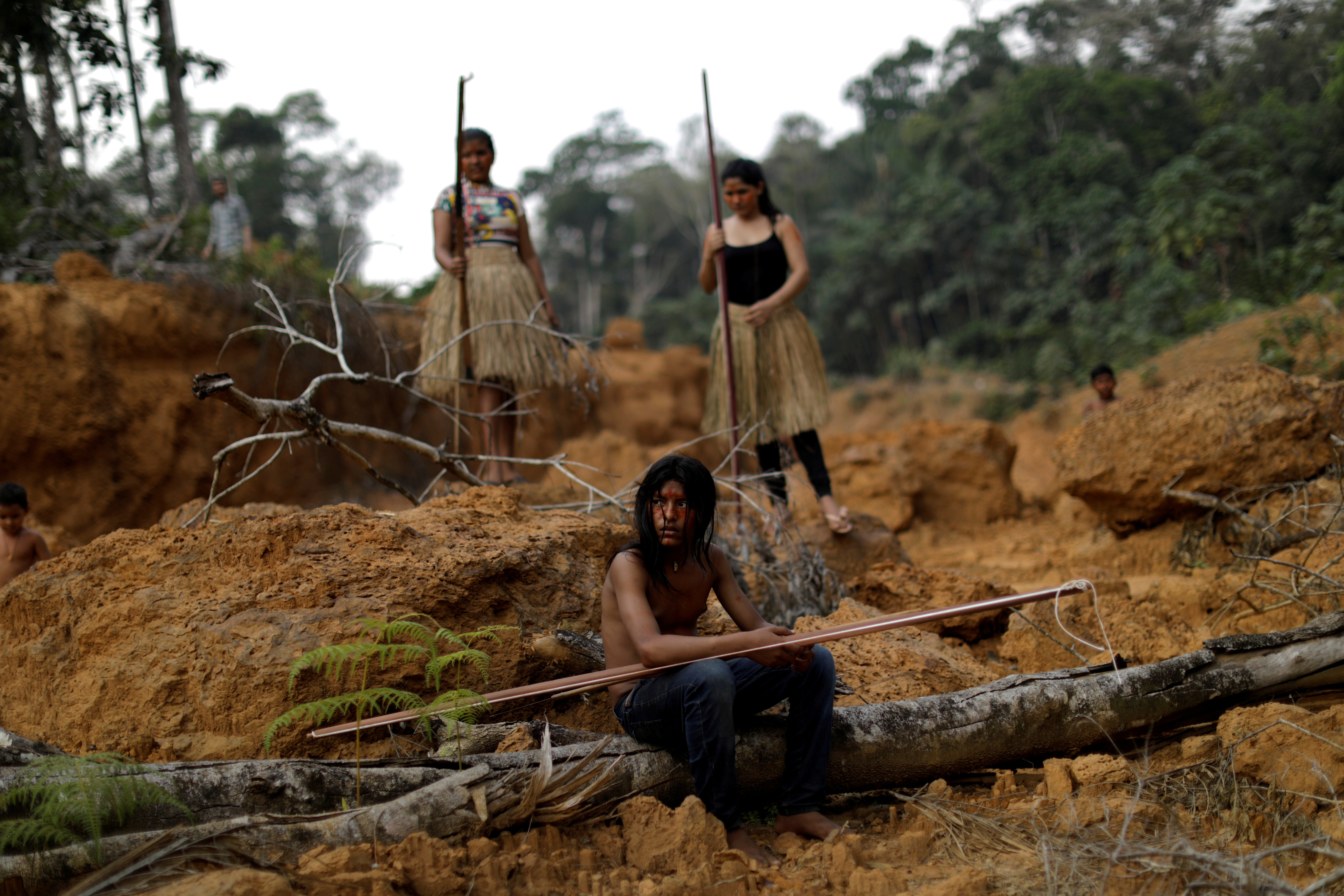Indigenous people from the Mura tribe show a deforested area in unmarked indigenous lands, inside the Amazon rainforest near Humaita