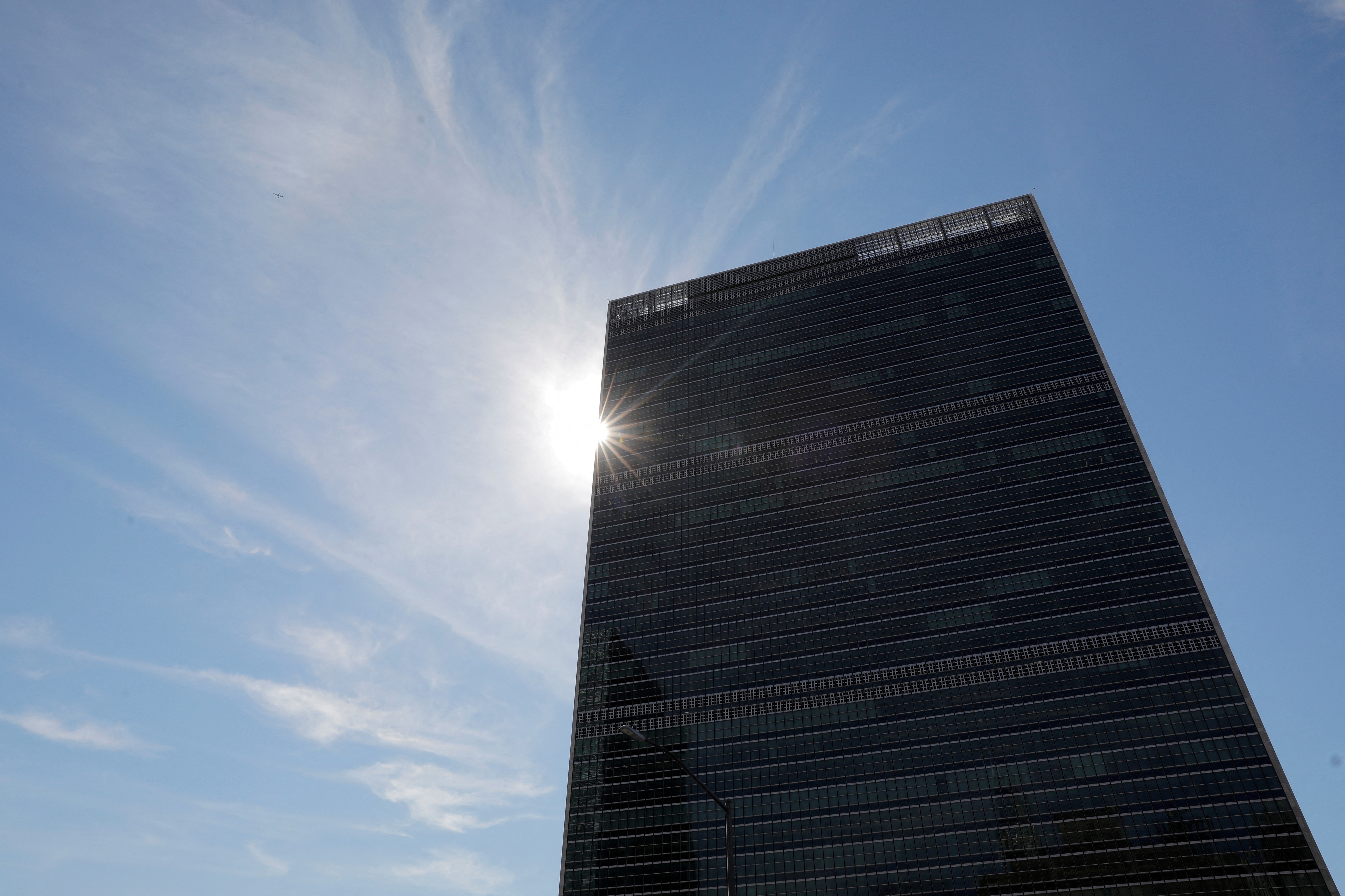 The sun shines behind the United Nations Secretariat Building at the United Nations Headquarters in New York City