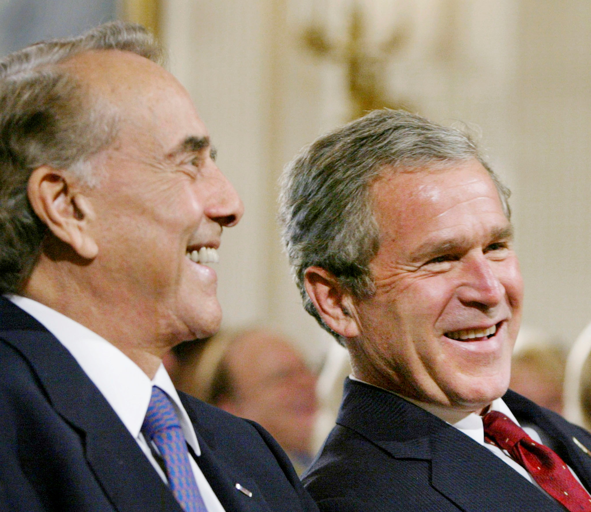 U.S. President George W. Bush sits with former U.S. Senator Bob Dole during a ceremony honoring the six-month anniversary of the USA Freedom Corps, in the East Room of the White House, July 30, 2002. REUTERS/Larry Downing/File Photo