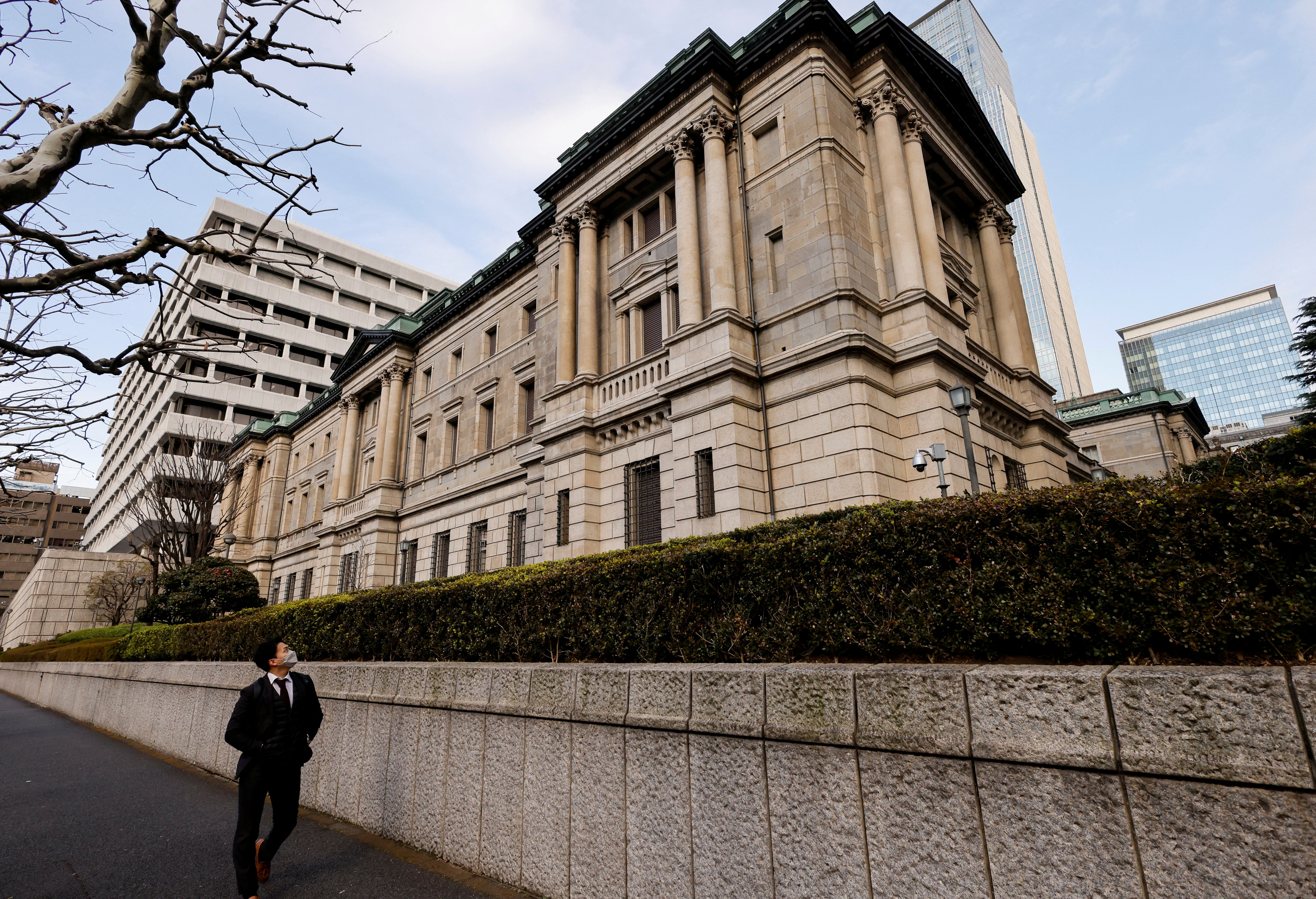 A man walks past the headquarters of Bank of Japan in Tokyo