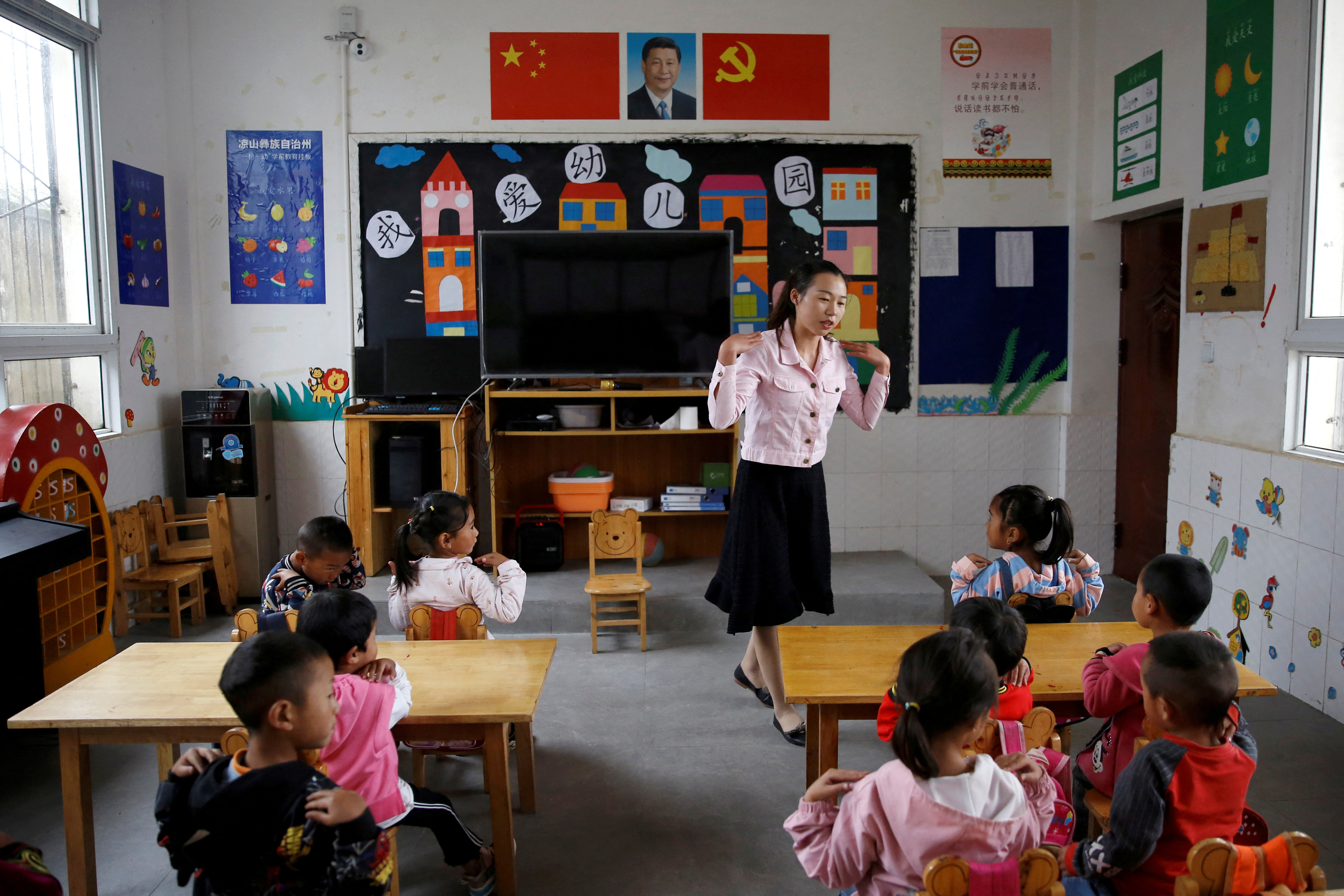 Teacher gives a class to children at a preschool in Xujiashan village, in Haitang