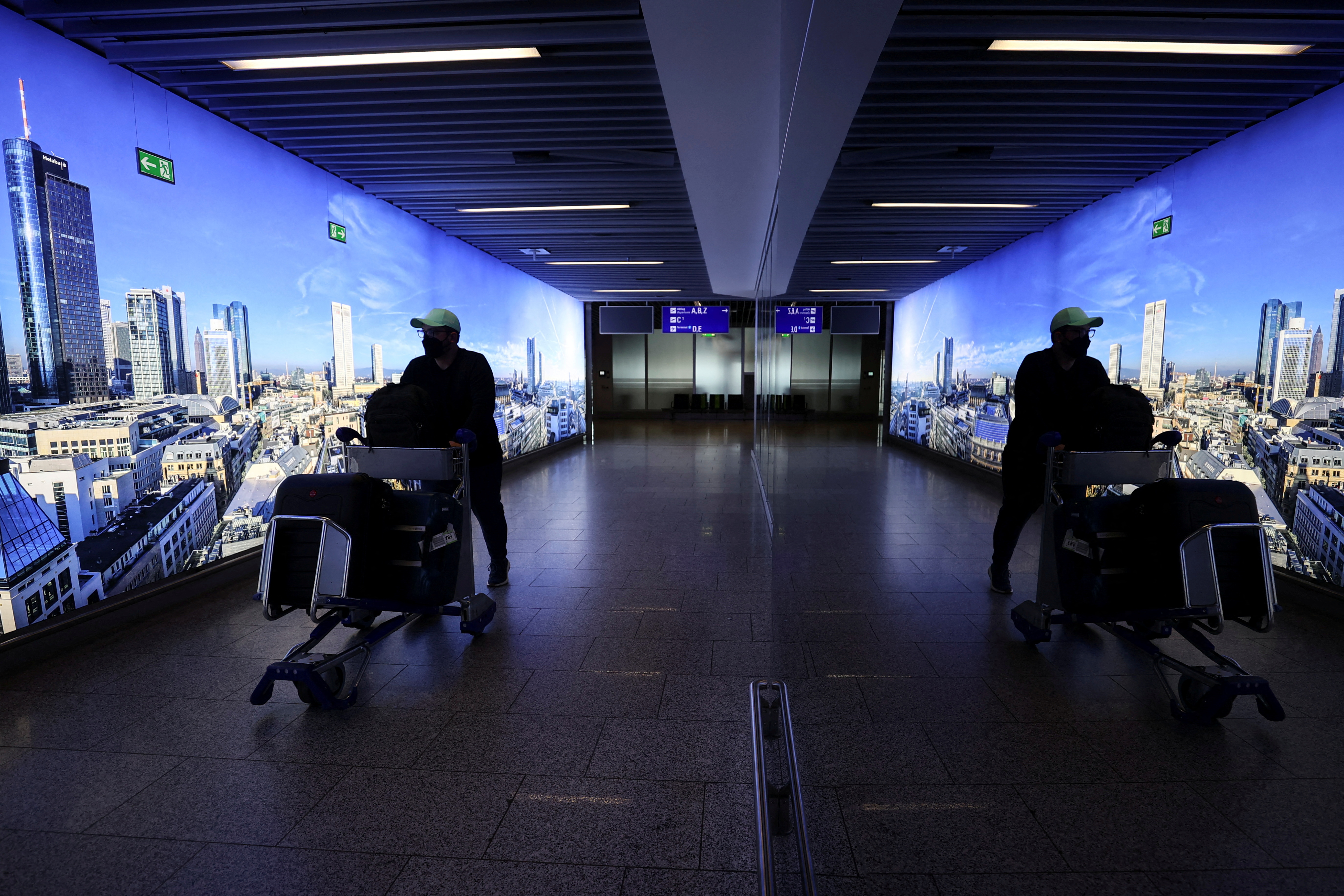 A man pushes a cart through Frankfurt airport, Germany