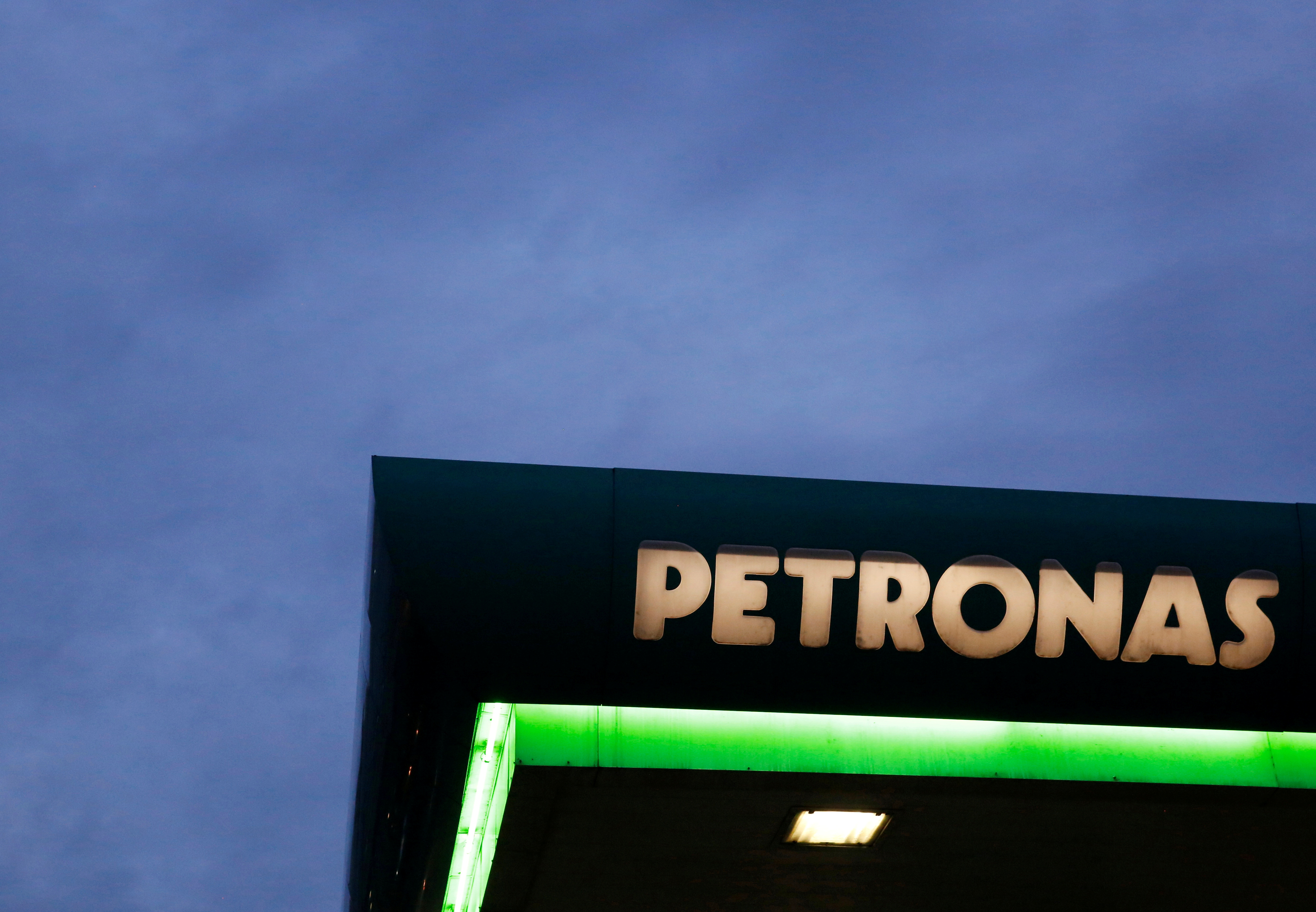 RCOMFILE PHOTO: A logo of a Petronas fuel station is seen against a darkening sky in Kuala Lumpur
